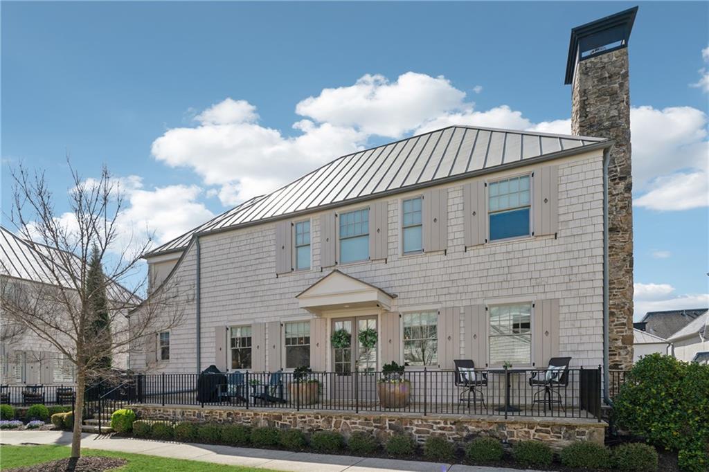 Discover the art of luxurious living in Avalon, a top-tier community where shopping, dining, and entertainment are all within reach. This contemporary home features designer touches, stylish lighting, and wide-plank hardwood floors. The bright interior showcases an open layout, high ceilings, and adaptable flex spaces. The designer kitchen, with its marble countertops and backsplash, flows effortlessly into a cozy living area with a fireplace. The master suite opens to a porch with a fireplace, offering breathtaking views of the lively Avalon scene. Spacious en suite secondary bedrooms provide comfort for family and guests. As part of the Garden Cottages, this home surrounds a beautiful greenspace and offers easy access to the community pool. Enjoy a lifestyle of luxury and convenience in this remarkable home.