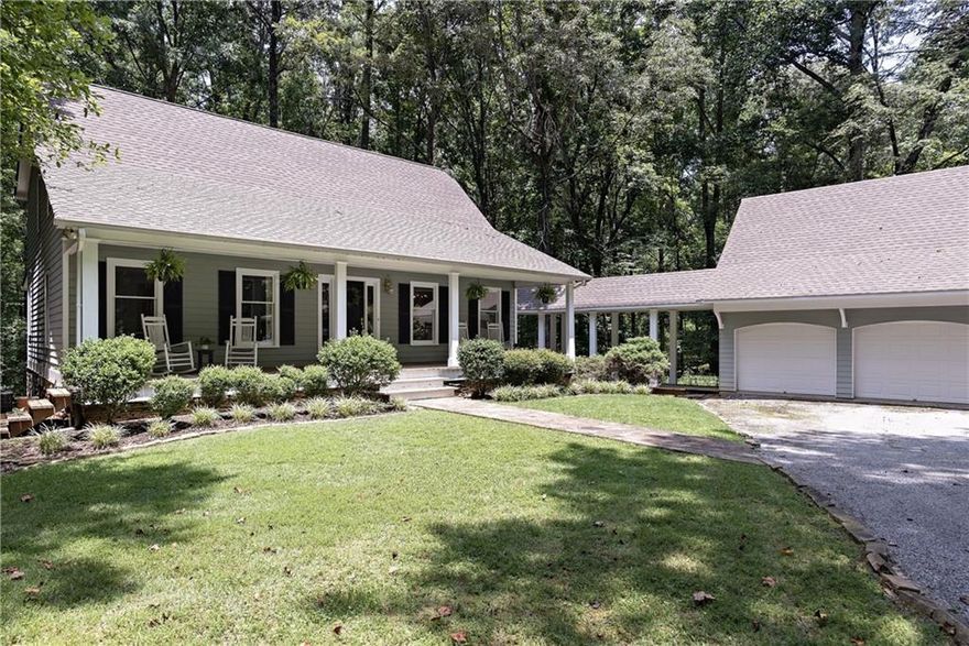 A Rare opportunity to own a beautiful, one-of-a-kind, 5 acre wooded estate which features two separate residences offering a total of six bedrooms and four full bathrooms. A small farm, it's tucked away and feels as if you're in the mountains! You'll love the serene and tranquil setting in Cherokee County just minutes from Roswell, Alpharetta, Cumming, Canton or Marietta. Encounter the wonders of nature with grazing deer, wild turkey or Canadian geese on a nearby pond. Located in an Equestrian area of Cherokee County, you can bring horses if you like. There's plenty of space on the property for pastures. Enter the private gated property on a long winding driveway which leads to a charming cape cod style home which is the primary residence. A large rocking-chair front porch welcomes you to this lovely home.  The homestead features a separate second residence/guest house above a detached 3 car garage which adds an additional 1,000 square feet of above grade finished square footage. THE SECOND RESIDENCE HAS AN ANNUAL RENTAL INCOME OF $18,000-$20,000 PER YEAR SINCE 2019!  It can be leased for the rental income, accomodate multi-generational living, extended family or a Nanny. You could even run your business from the second residence. The property can be subdivided as well. Possible owner financing with substantial down payment.There's also a climate controlled storybook- like garden shed with pitched roof and stained glass, just perfect for an art studio, a playhouse, a private retreat or anything your heart can imagine. The main home features pine floors, a fireplace with a raised stone hearth and mantle which sits in the middle of the home, stainless steel appliances, a large pantry and a mudroom. There's a spacious bedroom and full bath on the main level which has been re-purposed by the current owner as a living room so you could have 2 primary bedroom suites, one upstairs and one on the main level. The two additional bedrooms upstairs share a jack and jill bath. The main residence also features a detached 2 car garage which is connected to the residence through a covered breezeway for a total of 5 garages. There's a large sunroom that spans the back of the home just off the kitchen and greatroom with built-in shelving. The sunroom opens to the deck overlooking the woods. The dining room is spacious and will accommodate your large family gatherings. A full unfinished basement can provide ample storage or finish it out for additional living space.  Outside, there's a large screened-in porch off of the walk-out basement which overlooks the fenced back yard. There's several garden areas, a basketball court and horseshoes. It's ready for trail installation throughout the acreage. Plenty of room for a pool. Enjoy refreshing water from the well. It's a beautiful, private paradise to love and call home.