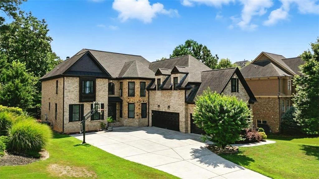 Don’t miss this exceptional home in one of Suwanee’s most desirable communities! Located within the award-winning North Gwinnett School District, this stately four-sided brick home offers an unbeatable combination of location, space, and quality. Being close to downtown Suwanee, you’ll enjoy easy access to local parks, restaurants, walking trails, and family-friendly events throughout the year.
Set on a beautifully landscaped lot, the home features a side-entry three-car garage that enhances both curb appeal and functionality. Inside, you'll find refinished hardwood floors, elegant trim work, and a flowing floor plan designed for both comfort and style. The gourmet kitchen is equipped with top-of-the-line stainless steel appliances and opens to a vaulted keeping room with a cozy fireplace, perfect for everyday living or entertaining.
The impressive two-story great room features a second fireplace, built-in shelving, and overlooks the fenced, professionally landscaped backyard—an ideal space for gatherings or play. A main-level office or study provides a quiet, private work-from-home area.
Upstairs, oversized bedrooms each have access to a private full bathroom, offering both luxury and privacy.
The finished terrace level adds incredible flexibility with two additional bedrooms, a full bath, and multiple entertainment areas—perfect for movie nights, a game room, or extended guest stays.
From top-rated schools and thoughtful design to its unbeatable location near everything Suwanee has to offer, this home truly has it all.