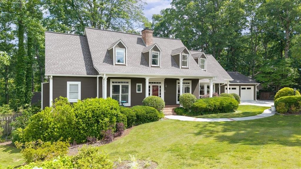 Location and privacy? Welcome to your own hidden haven in the heart of East Cobb, where every day feels like a peaceful secluded retreat, yet you are minutes to award winning Lassiter High School cluster, shopping, dining and all East Cobb has to offer. Set on 3 private, wooded acres looking out upon a peaceful pond, this 5 bed and 4 full and 2 half bath home is lovingly designed to blend timeless charm with everyday comfort. Step inside to witness a custom open-concept interior-no cookie cutter designs here- with a spacious family room that anchors the heart of the home. The fireside great room flows seamlessly into a newly renovated fresh white kitchen with quartz tops and backsplash, 2 sinks, double oven, induction cooktop and stunning skylight. A cozy library/office is, flanked by antique doors imported from Europe and tucked off the great room. Picture-perfect views of the lush, park-like backyard can be seen from nearly every room. A screened porch just off the kitchen and great room invites you into a serene outdoor sanctuary. The main level also features the pristine primary suite nestled in its own private wing, featuring a beautifully renovated bathroom. The formal living and dining rooms are grand yet inviting, with French doors that open to the main living areas. A separate entrance next to the garage provides a warm, functional welcome for guests or extended family.
Upstairs, you'll find oversized secondary bedrooms with multiple walk-in closets and individual charm. Both bathrooms upstairs have been fully renovated in 2025. A cozy loft area offers the perfect nook for reading, gaming, or play.
Downstairs, the fully finished terrace level was renovated in 2022 and features its own entrance, bar area/kitchenette, bedroom, full bathroom, spacious living area, and a second laundry room—ideal as a guest suite, in-law apartment, or even a rental opportunity. The driveway includes extra parking for added convenience. The basement also offers ample storage solutions including finished and unfinished space.
What's more? the backyard is a true sanctuary: winding paths, antique garden gate, custom shed, and even a hidden picnic spot—all designed to surprise and delight. This home offers ample space to grow, create, and connect—ready for its next family to make it their own.