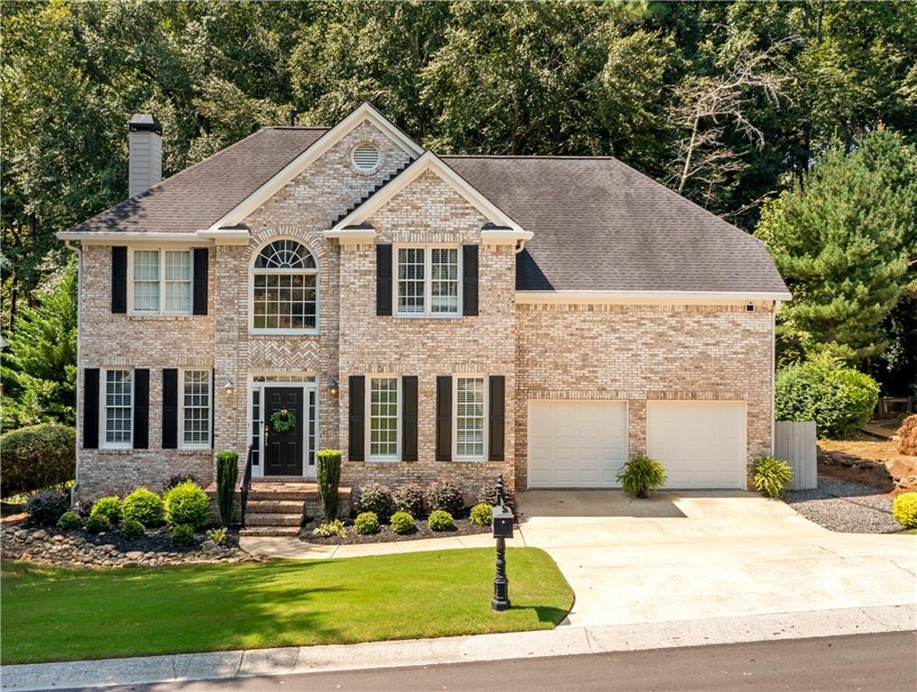 This magnificent 5 bedroom, 3 1/2 bathroom property offers refined living at every turn. Boasting an all-brick front, it is nestled just off a quiet cul-de-sac in this golf course community. The home provides welcomed privacy where you don't have to worry about the hustle & bustle of neighborhood traffic. With two stories plus a finished terrace level, this property effortlessly blends spaciousness with warmth. The main level features an open living room with a vaulted foyer. There is a gourmet kitchen with granite countertops, stainless-steel appliances, and plenty of counter space. Upstairs, the owner’s suite boasts a generous sitting area framed by windows, a recently-renovated ensuite bathroom with marble tile, and a spacious walk-in closet. The laundry room is also located upstairs along with four of the bedrooms which makes washing clothes a breeze. The finished terrace level offers numerous possibilities with a versatile rec room - perfect for media, playroom, or home gym. A bedroom and a full bathroom is also located on the terrace level. You can enjoy some coffee while sitting outside in one of the two screened-in porch areas or take advantage of a the large deck while grilling some delicious food. A gentle creek meanders along the rear of the property, offering a serene natural backdrop. The home has a BRAND NEW tankless hot water heater just installed in August 2025. AC ducts and dryer vent were all just cleaned as well. This home is in the Towne Lake Hills East subdivision where you can enjoy golf, swimming, and tennis too. Come take a tour to see what all this beautiful property has to offer!