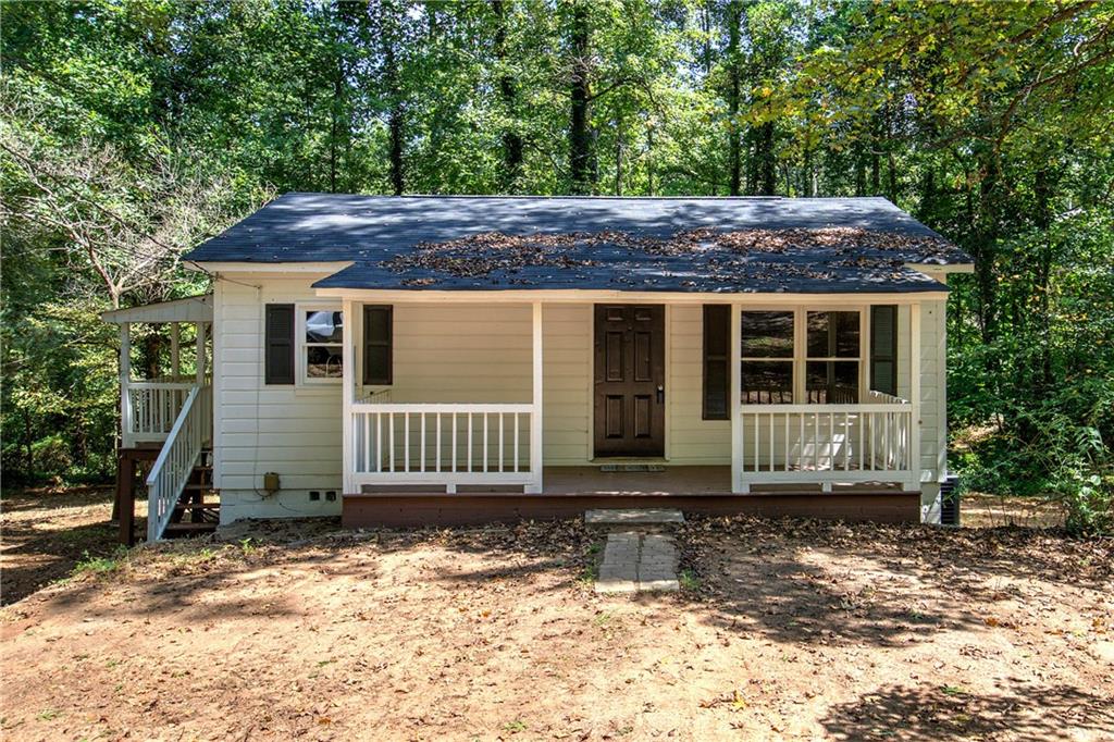 Welcome home to 269 Bobo Road! This beautifully renovated ranch-style combines modern upgrades with classic charm, creating a move-in-ready retreat. Inside, the home showcases refinished wood flooring throughout, freshly painted interiors, and sanded ceilings and walls for a smooth, updated finish. Every room is enhanced with stylish new light fixtures, while three new interior doors add consistency and character throughout. The kitchen has been thoughtfully updated with freshly painted white cabinets, new granite countertops, a new sink and exhaust hood, and a brand-new Samsung stainless steel stove. An ice-maker water line has been added for convenience, making the space as functional as it is attractive. The primary suite and an additional bedroom are located on the main level, offering comfort and flexibility. The bathroom has been refreshed with a painted tub and a new insert. A new 2-ton Goodman HVAC system ensures energy-efficient climate control, while plumbing has been brought up to code. Additional mechanical updates include a septic system that has been pumped and inspected. Exterior updates elevate both curb appeal and peace of mind. The home boasts a brand-new roof (April 2025), reinforced side porch support beams, new stairs, siding repairs with fresh paint, and professional landscaping with a gravel driveway and newly planted grass in the front yard. With a complete termite inspection, ample parking, and every major system updated, this home offers the perfect balance of character, quality, and convenience.