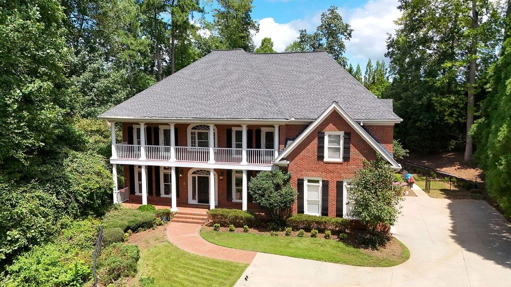 Tucked away in a quiet cul-de-sac within the prestigious St. Marlo Country Club, this impressive 7-bedroom, 7.5-bath residence combines luxury, comfort, and thoughtful design. Step into a soaring foyer that sets the tone for sophistication, flanked by a richly appointed library, an expansive formal dining area, and a gracious fireside great room—ideal for entertaining. The main level features a private guest suite, offering convenience and privacy for visitors. The gourmet kitchen is a chef’s dream with elegant cabinetry and a seamless layout that opens into a warm, fireside keeping room. Just beyond, a screened-in porch overlooks a beautifully landscaped, fenced backyard retreat, complete with a gazebo, a 6-person hot tub, and a fully equipped outdoor kitchen—perfect for hosting or simply unwinding. Upstairs, the oversized primary suite delivers a spa-like experience with a steam shower and a custom walk-in closet designed with his-and-hers sections. Four spacious secondary bedrooms, each with its own en-suite bath, plus a versatile media/bonus room, ensure space and comfort for everyone. The finished terrace level expands the living space with a second full kitchen and a private in-law or nanny suite—ideal for multigenerational living. Additional upgrades include newly refinished hardwoods, landscape lighting, a tankless water heater, and two supplemental water heaters. The 3-car garage features a sleek, slip-resistant, trackless floor for added utility and style. This exceptional home offers refined living in one of the area's most sought-after gated communities. A rare opportunity to own a home that truly has it all.
