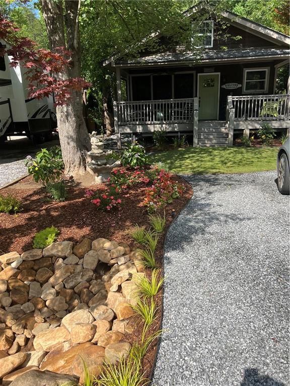 Cute, quaint, and tucked back in a privately gated RV/Camper campground. Welcome home to this charming 1 bedroom 1 bath cabin with a loft. This studio cabin is decked out with cute retro appliances. Has a wrap around porch with a RV/camper hookup up to 30ft long. This neighborhood has a private pool, is very well maintained and manicured landscapes. There is a trout stream in the park for fishing, golf carts allowed to visit the camp grounds, they host seasonal holiday events and activities. Make this quaint little cabin in the woods your home! Cabin sold AS IS.