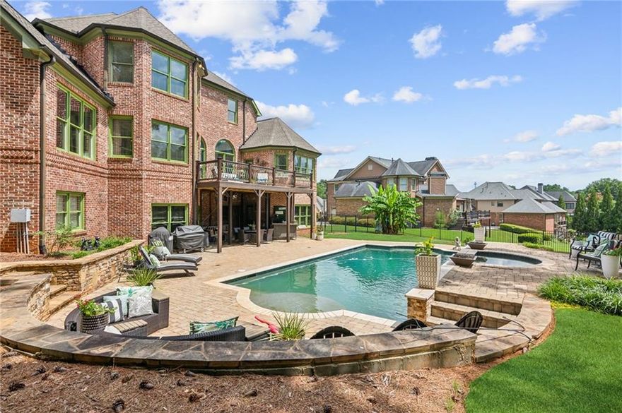 HEATED POOL!!! Experience the pinnacle of luxury in this meticulously crafted custom stone and brick home in the Miramonte Hills Subdivision. With high ceilings and hardwood floors throughout, this professionally designed interior exudes elegance. Relax in the spacious living room with beautiful coffered ceilings, or opt to gather in the keeping room with custom bookcases and vaulted wooden ceiling. This home features 5 bedrooms and 3.5 baths, including an additional large suite with a bathroom and walk-in closet. It also offers a large bonus room that can be used as a viewing room. The exterior trim has been freshly repainted. Some windows have been recently replaced. For the ultimate staycation experience, the backyard features a gorgeous and large custom pool and hot tub, with multiple waterfall features and gas fire bowls. A three-car garage and ground-level entry add convenience and plenty of space.  Large terrace level stubbed for bath. Low HOA fee just $385 per year.