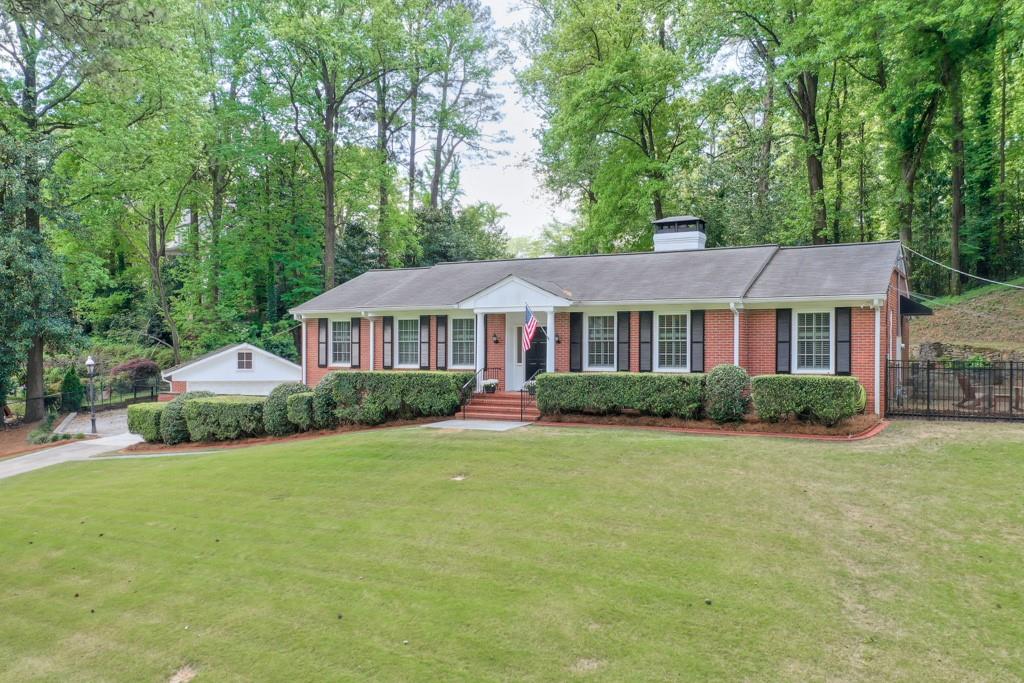 Updated Ranch with rare SUPER WIDE LOT on quiet side street in Chastain Park!!! One of the last remaining opportunities to spread out and have most everything on one level. An open white kitchen overlooks the family room and the backyard through a wall of windows and french doors. The kitchen features Stainless Appliances, Granite Counters, and under Cabinet Lighting. One step gets you out onto the massive rear brick paver patio which is ideal for grilling, relaxing and/or gathering with family or friends. This interconnected outdoor living space also features a built-in stone fireplace. For those with multiple vehicles and hobby gear, the oversized detached garage/shop space combined with the extra off street parking may be just what you need. Here's your chance to enjoy the Chastain Park lifestyle - scroll to the end for photos! I live nearby and am happy to answer any questions.