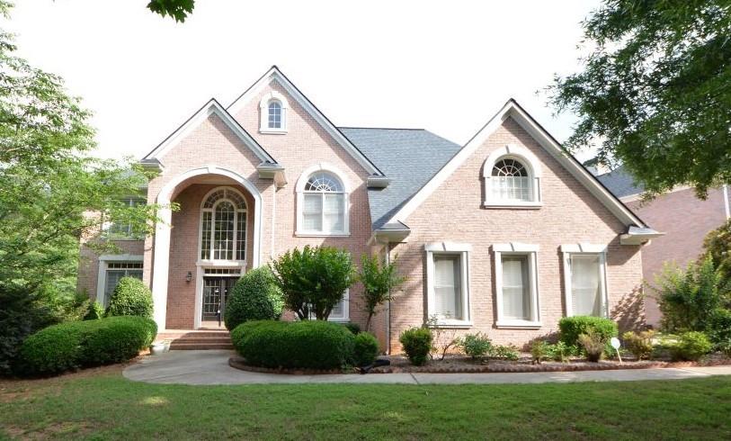 Beautiful and well-maintained three-sided brick home in a gated community. The most popular floor plan in Stonebrier! With five bedrooms and four full baths, this residence offers luxury and comfort. New roof. Two-story foyer. Hardwood floors on main. The office can be used as an In-law suite/guest bedroom on the main floor. Upgraded lighting. Open floor and high ceiling great room with built-in bookcases. The kitchen features granite countertops, new stainless steel appliances, and a coffered ceiling, ideal for culinary enthusiasts. Bright kitchen with granite counters. Private backyard. Loft on 2nd floor. Spacious master suite with sitting area and an additional exercise/study room. Renovated master bath. A one-bedroom suite has its own private bathroom. The other two spacious bedrooms share a jack-and-jill bathroom. Walk to school. This home is located in the prestigious Stonebrier at Sugarloaf community, offering amenities such as swimming, tennis, a park, and a pond. Close to I-85, Hwy 120, Hwy 316, Sugarloaf Mills Mall, Gwinnett Chamber of Commerce, and across from Sugarloaf Country Club. A lovely home in a great location, PEACHTREE RIDGE Schools, spacious and open floor plan. A MUST SEE!