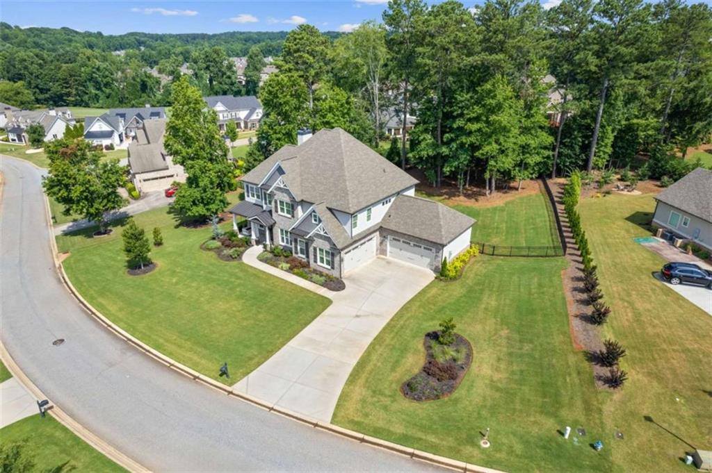 AMAZING OPPORTUNITY WITH RECENT PRICE IMPROVEMENT AND MOTIVATED SELLERS! NOW IS YOUR TIME TO OWN THIS GORGEOUS CUSTOM-BUILT HOME IN HIGHLY SOUGHT JACKSON COUNTY SCHOOLS SYSTEM. Enjoy this LIKE NEW, 5 bedroom / 5 FULL bath home perfectly appointed on a large, level lot with over 4,000 sq ft of beauty and tons of natural light. 10 ft ceilings, home office/dining room with POCKET DOOR, great room with BUILT-IN cabinets, sitting room, massive media room and 4-CAR oversized garages with ELECTRIC CAR CHARGING STATION are just a few of the many fabulous features. This kitchen is an entertainer's dream; equipped with a breakfast nook, double ovens, upgraded cabinets with lighting, extra-large island and CAMBRIA quartz countertops. Just steps away cozy up in the ship lapped sitting area and enjoy the electric fireplace or find more warmth in the great room using the 2nd wood burning brick fireplace. Travel up the wide stairs to find a massive media room, laundry room and elegant primary suite complete with expansive custom closet system, spa bath with marble tile, vaulted ceiling and Woodbridge SMART TOILET. Outside find a front porch with custom swing and MOSAIC TILE floor or travel to the FENCED backyard to sit under the covered patio. This is a huge backyard, perfect for a pool! Enjoy all this home has to offer in the terrific Traditions of Braselton community with access to pool, clubhouse, fitness center, tennis, PICKLE BALL, optional GOLF, RESTAURANT & the AWARD-WINNING Jackson County schools just a golf cart ride away! ***AGENTS YOU ARE PROTECTED IF YOU CANNOT SHOW, I AM HAPPY TO HELP AND SHOW THIS GORGEOUS HOME TO YOUR BUYERS***