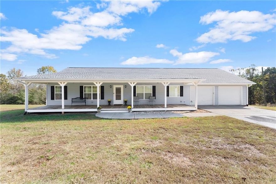 This beautiful custom ranch with rocking chair front porch sits on over 7 acres that is partially cleared and wooded. The house has an open concept with masonry fireplace that leads to the dining room and large kitchen. Split bedroom plan with large master on the main. Come enjoy the peaceful private backyard from the covered back deck. The full basement has a finished bath and would make a great in-law suite and a boat/utility door. Looking for that home-based business? This home offers a separate 4 car detached garage with plenty of space and parking. Just minutes to Ga 400 or Hwy 53 this is the perfect opportunity for business, pets, and family with the great schools nearby.