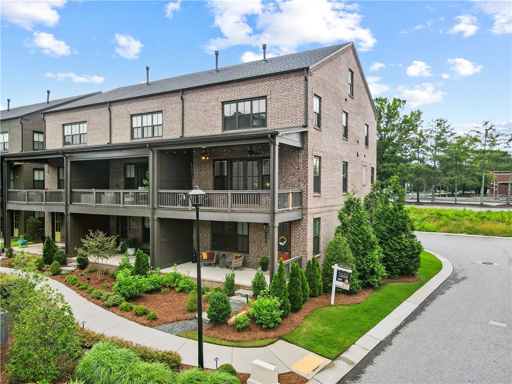 Modern 3-Story Corner Townhome in the Heart of Halcyon – Alpharetta, GA
Welcome home to this stunning 4-bedroom, 3.5-bathroom corner townhome in the highly desirable Halcyon community — where style, comfort, and location come together beautifully. Built in 2021 and move-in ready, this home features hardwood floors on all levels (no carpet!), a 2-car garage, and elevated finishes across three spacious levels.
Step onto the inviting covered front porch — the perfect spot to enjoy your morning coffee or unwind in the afternoon — and enter into a bright, open foyer on the lower level. This floor includes a guest bedroom with views of the porch, a full bathroom, a large storage closet, and a convenient built-in bench near the door to the garage. There’s also a second entrance at the back of the home next to the garage for added convenience.
The main level is designed for everyday comfort and entertaining. The gourmet kitchen boasts quartz countertops, a large island with sink and seating, a gas cooktop with vent hood, built-in oven and microwave, 3-door stainless steel fridge, tile backsplash, and a large walk-in pantry. Across the kitchen, a bar nook with wine cooler and stone counters offers a stylish touch. The dining area is located near a tucked-away desk nook, ideal for a home office setup. The cozy living room, complete with a gas fireplace, opens up to a private deck, perfect for indoor-outdoor living.
Upstairs, you’ll find the owner’s suite featuring tray ceilings, a spa-inspired bathroom with double vanities, a glass-enclosed walk-in shower, a private water closet, and a generous walk-in closet with built-ins and natural light. Two additional guest bedrooms share a full bathroom with a stone countertops vanity and shower/tub combo. A laundry room with washer and dryer and a large linen closet provide extra convenience.
As an added bonus, this home has elevator potential — three oversized closets located on each level (including the pantry on the main floor) are perfectly aligned to be converted into an elevator shaft in the future, if desired.
The Halcyon community offers the ultimate live-work-play lifestyle, with walkable access to top-tier shopping, dining, and entertainment — including Trader Joe’s just down the street! Community amenities include a covered gazebo for events, green space, a sparkling pool, and a cozy firepit area perfect for socializing year-round.
Unbeatable Location: Just off GA-400, you’ll enjoy easy highway access for a quick commute to Atlanta, top-rated schools, and everything North Fulton has to offer.Location. Comfort. Community. This townhome checks all the boxes — schedule your tour today and make it yours!