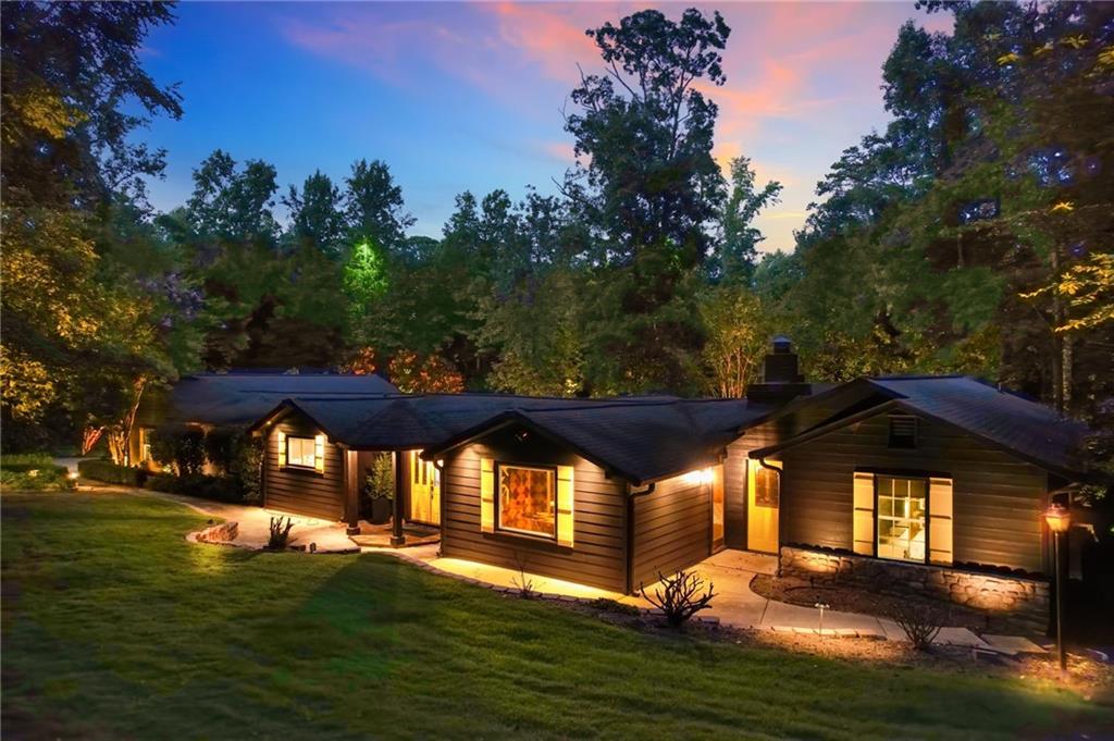 Experience upscale lakeside living on Lake Allatoona in this meticulously renovated and thoughtfully curated ranch estate, complete with deep water access and your own two-slip, two-story boat dock featuring Ipe wood decking and panoramic lake views. Positioned on 1.26 acres, this nearly 5,000-square-foot residence offers a refined blend of luxury design, functional layout, and year-round resort-style living.
The home features six bedrooms, four bathrooms, and three bonus rooms, including a spacious flex room off the kitchen ideal for a home office, playroom, or game room. The primary suite on the main level is a true sanctuary, showcasing grasscloth wallpaper, a designer chandelier, spa-inspired en suite bath, and a generous walk-in closet. Below the suite, a private lower level adds even more space, featuring a custom dressing room with built-ins for hats, handbags, and shoes, plus a separate room ideal for a private office, home gym, or wellness space.
A second basement on the opposite wing of the home functions as the sixth bedroom, perfect as a media room, guest suite, or private retreat.
The interior has been elevated with all-new engineered hardwood floors, a bold charcoal color palette, and a fully renovated chef’s kitchen with stainless steel appliances, water-cut marble backsplash, and custom cabinetry. A stylish mudroom with built-ins and a beverage center adds functionality, while Visual Comfort and Regina Andrew lighting, along with Buster + Punch light switches and outlets, deliver unmatched designer detail throughout.
The home also includes climate-controlled attic and garage spaces, with the oversized four-car garage offering ample room for vehicles, toys, and storage. A golf cart and hot tub are included in the sale for the ultimate lake life convenience.
Outside, the spacious deck, in-ground pool, flagstone patio, and large fire pit create the perfect environment for entertaining or relaxing. The yard is professionally landscaped, fully irrigated, and enhanced with landscape lighting.
Furniture is available for purchase, and the boat is negotiable as well, offering a rare opportunity to move into a fully turnkey lakefront estate.
With no HOA (VCCI is a civic club with optional membership), this is a truly one-of-a-kind property that combines luxury finishes, thoughtful upgrades, and effortless access to Lake Allatoona.