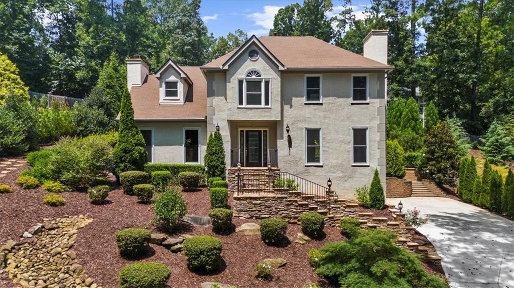 Perched on a scenic hilltop with peaceful wooded views, this classic two-story traditional home offers timeless charm and a functional layout for everyday living. The main level features a separate dining room, formal living room, and a cozy den—perfect for entertaining or relaxing. The eat-in kitchen is outfitted with white cabinetry, granite countertops, and a double oven, ideal for anyone who loves to cook. Gorgeous 6-foot Pella windows line the main level, flooding the home with natural light and offering beautiful views of the meticulously landscaped backyard.
Upstairs, you’ll find four generously sized bedrooms and two full bathrooms, providing comfortable accommodations for family or guests. The oversized master suite includes an attached fourth bedroom—ideal for a home office, nursery, or private sitting area—offering added flexibility to suit your lifestyle. A half bath on the main level adds extra convenience.
Located in a vibrant community that includes a fishing lake, swimming pool, playground, and tennis courts, this home offers not just a place to live, but a lifestyle to love. **Driveway replaced in early 2025. Home comes with a 6-month 2-10 Home Warranty!