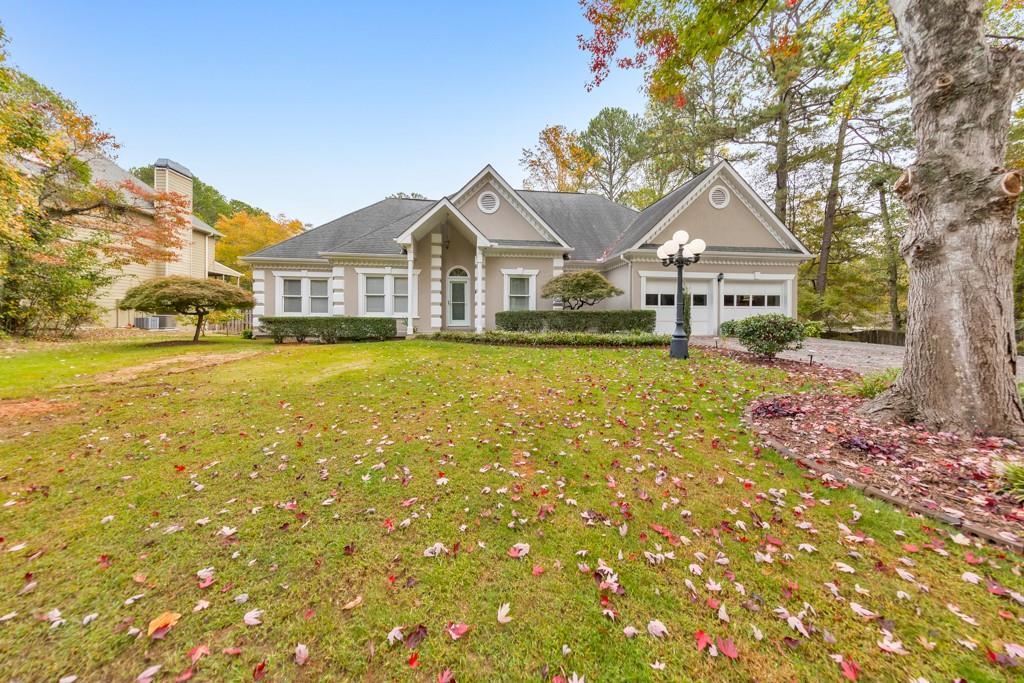 Welcome to this inviting 3-bedroom, 3.5-bathroom home nestled in the sought-after Shannon Trace community. Step inside to a welcoming foyer with a versatile sitting room or office to one side and a formal dining room to the other. The kitchen is a chef's delight, featuring white cabinetry, stone countertops, an island, pantry, and a cozy breakfast area. The fireside family room provides a perfect gathering space, with a convenient half bath and laundry area nearby. The spacious primary suite on the main level offers tray ceilings, a private door leading to the back deck, a walk-in closet, and a luxurious ensuite with double vanities, a glass-enclosed shower, and a whirlpool tub. Two additional main-level bedrooms share a full hall bathroom, perfect for family or guests. Downstairs, the basement expands your living options with two versatile bonus rooms, ideal for a recreation room or home gym, and a sizable unfinished workshop with a boat door. Outdoor living is exceptional here, featuring a covered deck, expansive patio space on the terrace level, a fully fenced backyard, lush landscaping, a charming gazebo, and an above-ground pool for endless relaxation and fun. Located in the McEachern High School district and close to premier shopping and dining, this home offers convenience, style, and plenty of space to make lasting memories!