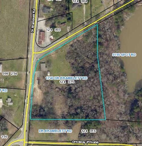 COMMERCIAL PERMITTED 6.35 Acres Corner Lot at Spot and Dr. Bramblett RD. Strong growth areas with several upcoming Residential subdivisions and shopping centers. PERMITTED to build shopping center, Liquor store, Retail Grocery Store, Office, Fast food restaurants (no drive thru). Excellent Location, joins the greenway walking trail to Sawnee Mountain Park.