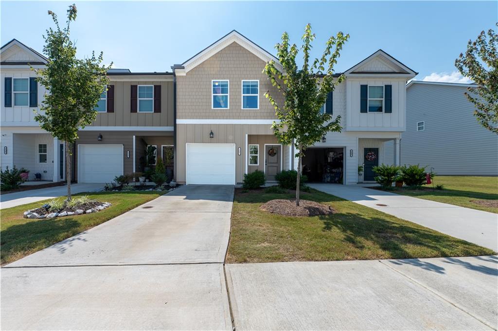 Charming 3-bedroom, 2.5-bath home in the heart of Hoschton, just steps from Hoschton Café. The open-concept main level features LVP flooring, a kitchen with granite countertops, ceramic tile backsplash, and stainless steel appliances overlooking the family room and dining area. Upstairs, the oversized Owner’s Suite offers a separate tub and shower, dual vanity, and walk-in closet, with two additional bedrooms and laundry room completing the level. Enjoy community amenities including a pool and cabana. Explore nearby boutiques in Old Town Hoschton and relax at Chateau Elan Winery & Resort.