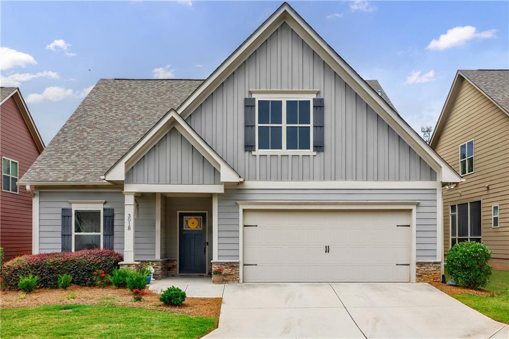 Step into refined living in this vibrant gated active adult community nestled in Marietta! From the moment you welcome guests onto your inviting front porch, they'll feel the warmth of home. Inside, the foyer boasts high ceilings, elegant crown molding, and hardwood floors, setting the tone for an impressive and comfortable lifestyle. The great room is perfect for relaxing or entertaining, featuring a cozy marble-surround fireplace that seamlessly opens to the stunning white kitchen-a true chef's dream. With granite countertops, soft-close cabinetry, a stylish tile backsplash, and stainless steel appliances, this space is both functional and beautiful. Sunlight fills the charming dining area, making every meal a delightful experience. The primary suite on the main level is a private retreat, with great natural light and a spa-inspired bathroom with a tiled shower and a spacious walk-in closet. A comfortable guest bedroom and bath complete the first floor, along with a charming covered side porch, perfect for sipping morning coffee or enjoying a quiet evening breeze. Upstairs, a versatile flex space with its own bathroom offers endless possibilities-it can serve as a third bedroom, a home office, or a creative space tailored to your lifestyle. This thriving active adult community provides a gated entrance, a clubhouse for social gatherings, and exterior lawn care, ensuring a low-maintenance and engaging environment. Experience the best of comfort, convenience, and connection-your dream home awaits!