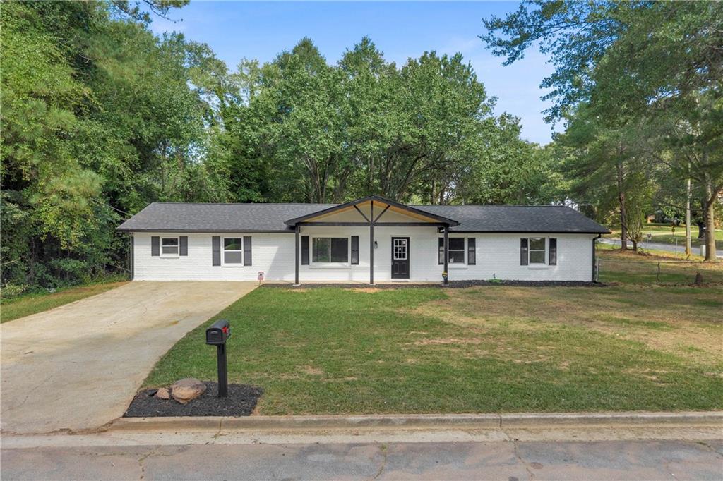 Welcome to this beautifully and fully remodeled four-bedroom, three-bath home situated in a prime location in Decatur, Georgia. This residence masterfully redefines functionality, having been thoughtfully and meticulously redesigned to maximize every inch of space. Prepare to be pleasantly surprised by the spacious and efficient layout upon entering this immaculate home. No expense was spared in the comprehensive renovation of this home. Light-toned luxury vinyl Plank flooring flows seamlessly throughout, complemented by brand-new carpeting in each bedroom. The open-concept design immediately welcomes you, with the custom-built kitchen serving as the centerpiece. Featuring large granite countertops that extend over a generous oversized island and breakfast bar, paired with elegant soft-white cabinetry, this kitchen offers abundant storage and meets every culinary and entertaining need. This single-story ranch boasts not one, but two generously sized master bedrooms—each with a full bath and walk-in closet—located on opposite ends of the home. This layout is perfect for an in-law suite, guest retreat, or multi-generational living. Additional upgrades include brand-new electrical and plumbing systems, fresh interior and exterior paint, a new roof, state-of-the-art HVAC, remodeled bathrooms, updated light fixtures, new windows, and much more. The list of enhancements is extensive and thoughtfully executed. Situated on a premium corner lot, this home offers a spacious, flat backyard—ideal for outdoor gatherings, gardening, or relaxation. Conveniently located near major highways and retail shopping, everything you need is just minutes away. This home offers the charm and appeal of a brand-new property—without the brand-new price tag. Opportunities like this are rare. Don’t miss your chance to own this exceptional Decatur home. Contact us today to schedule a private tour and experience firsthand the quality and craftsmanship that make this property truly special.
