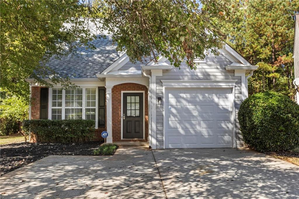 Tucked in a quiet Alpharetta community, this home has a simple sense of comfort that shows up the moment you walk in. The main level feels open yet grounded. Enter a two-story living room with warm natural light, a gas fireplace framed by built-ins, and a layout that connects seamlessly to the kitchen and out to the back patio. The wooded lot behind it makes mornings quieter and evenings calmer, a little pocket of privacy right where you want it.
The primary suite on the main floor adds effortless flow to daily life, while upstairs you’ll find two spacious bedrooms and a full bath that works well for guests, family, or a flexible home office setup. Freshly painted with new LVP flooring, updated light fixtures, and ceiling fans throughout, the home feels crisp and cared for. You’ll find thoughtful storage at every turn! Home provides two kitchen pantries, several large closets, and a garage with space for another car in the driveway without blocking anyone in.
Close to GA-400, Avalon, the Greenway, and all the conveniences of North Fulton. This is one of those homes that’s just easy to live in.