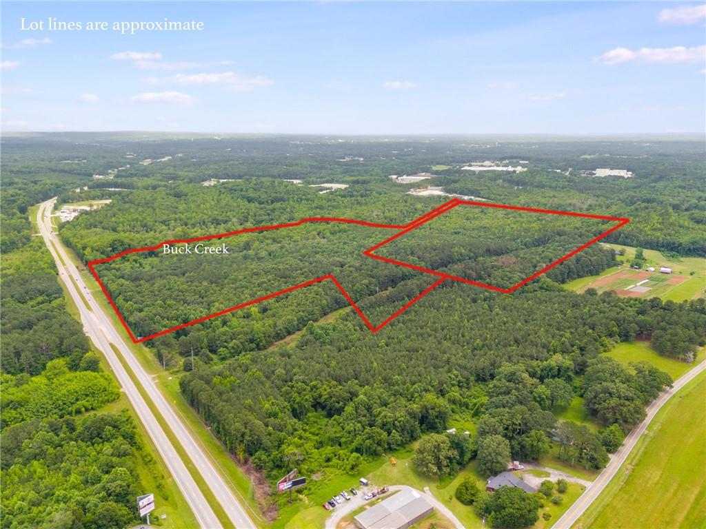 Aerial view of property's location with a forest and property parcel outlined