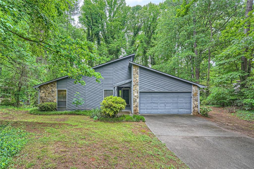 Lovely move in ready 3 bedroom, 2 bathroom contemporary ranch home. Don't miss this gem. Easy one level living. Laminate floors throughout. Kitchen features stainless steel gas range, fridge, dishwasher, and vent hood along with white cabinets and granite counter tops. Separate dining room is adjacent to kitchen. In the center of the house is a large spacious cathedral ceiling living room with wet bar. Three bedrooms, two bathrooms, and a two car garage round out the other side of the home. Relax or entertain on the back deck. Close proximity to i575, Hwy 92, Marietta, Woodstock, and all the shopping, dining, and entertainment East Cobb and Woodstock have to offer.