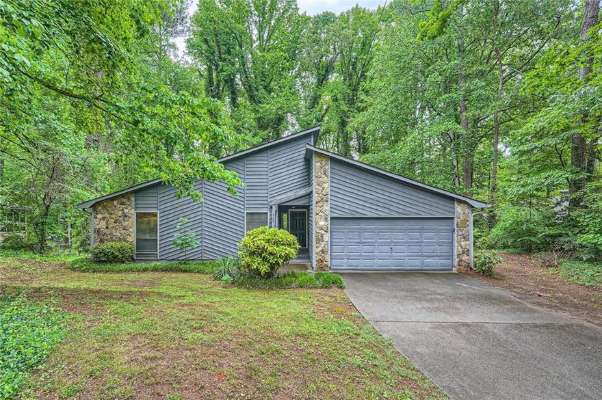 Lovely move in ready 3 bedroom, 2 bathroom contemporary ranch home. Don't miss this gem. Easy one level living. Laminate floors throughout. Kitchen features stainless steel gas range, fridge, dishwasher, and vent hood along with white cabinets and granite counter tops. Separate dining room is adjacent to kitchen. In the center of the house is a large spacious cathedral ceiling living room with wet bar. Three bedrooms, two bathrooms, and a two car garage round out the other side of the home. Relax or entertain on the back deck. Close proximity to i575, Hwy 92, Marietta, Woodstock, and all the shopping, dining, and entertainment East Cobb and Woodstock have to offer.