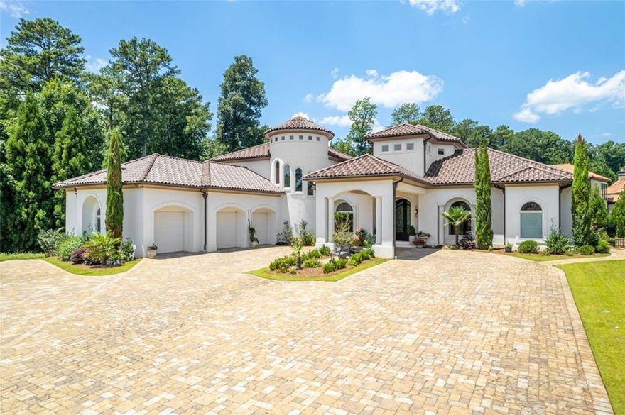 This masterfully designed Mediterranean estate, crafted by its original owner, effortlessly combines timeless elegance with contemporary sophistication and is now being offered for the first time. Set in an exclusive cul-de-sac, you are welcomed through an exquisite grand iron and glass front door leading to an expansive living space adorned with flawless marble floors and striking fireplaces. The open-concept layout flows seamlessly into the resort-inspired backyard, where a captivating pool with limestone decking, meticulously manicured professional landscaping, and an oversized covered balcony create the ideal setting for extravagant entertaining. The chef’s kitchen is nothing short of a masterpiece, featuring custom European cabinetry, top-of-the-line integrated appliances, a private scullery, and opulent waterfall-edge countertops. The main level also boasts the serene owner’s suite showcasing unparalleled luxury, a refined private office perfect for work or study, and a spacious guest suite with en-suite bath that ensures privacy and comfort. Additional thoughtful touches include a sophisticated office and well-appointed laundry room with custom-built cabinetry. A dramatic curved staircase, framed by an expansive window leads upstairs to three generously sized en-suite bedrooms, including one with a private balcony overlooking the tranquil backyard—each offering a private retreat for family or guests. The lower level features an en-suite bedroom, fully equipped gym (which could easily be converted back to a bedroom), full bathroom, and state-of-the-art home theater. The private elevator services all three levels, and every modern amenity has been meticulously incorporated to elevate your lifestyle. This extraordinary estate presents an unparalleled opportunity to own a flawlessly designed sanctuary where every detail has been thoughtfully curated for the most discerning buyer.