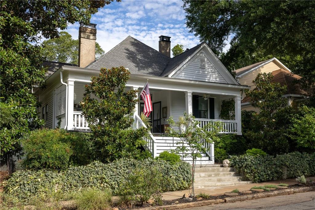Simply iconic. A front porch fit for Southern royalty welcomes you to a home that has graced Atlanta's history for more than a century. Lovingly restored, it blends historic soul with modern comfort at every turn. Inside the central hall, heart pine floors stained a dramatic black run beneath soaring 11-foot ceilings. The original 3-bedroom, 2-bath layout now lives as a 2-bedroom with a private primary suite, featured in Atlanta Magazine (May 2025). The former third bedroom serves as an elegant parlor, while the spacious primary retreat offers a private bath, custom closet, and direct laundry access. At the back of the home, the custom kitchen features quartz countertops, floor-to-ceiling cabinetry, LG appliances, gas stove, and designer lighting. An inviting eat-in area flows to the conservatory through double French doors, framed by Pella custom windows. The interiors are elevated by one of the most complete private collections of mid-century modern furniture and art in Atlanta, featuring pieces by Knoll, Eames, Nelson, and McCobb, curated with the precision of a design museum, yet intended for everyday living-select pieces will be available to purchase. The stand-up unfinished basement provides abundant storage, enhanced with federally approved Lexan windows. Now the outdoor oasis, a 16 x 36 heated saline pool and jacuzzi (Maliblue of Serenbe, 2019) anchor a Brendan Butler designed garden, shaded by three prominent live oak trees, and secured with an automatic gated entry. Renovated top-to-bottom in 2019, updates include: New architectural shingle roof-New HVAC-Whole-house vacuum system-All-new wooden windows with custom shutters and shades-Custom kitchen, Custom Laundry and Pantry (Full list of renovations available upon request) The 2021-built pool house is a one-bedroom, one-bath retreat with a kitchen, polished concrete floors, interior and exterior shower, front pool closet, rear workshop, and its own whole-house vacuum system. A rare opportunity to own a residence that pairs turn-of-the-century craftsmanship with high-end modern updates plus an incomparable mid-century furniture and art collection, ready for its next steward. Come on in, Precious.