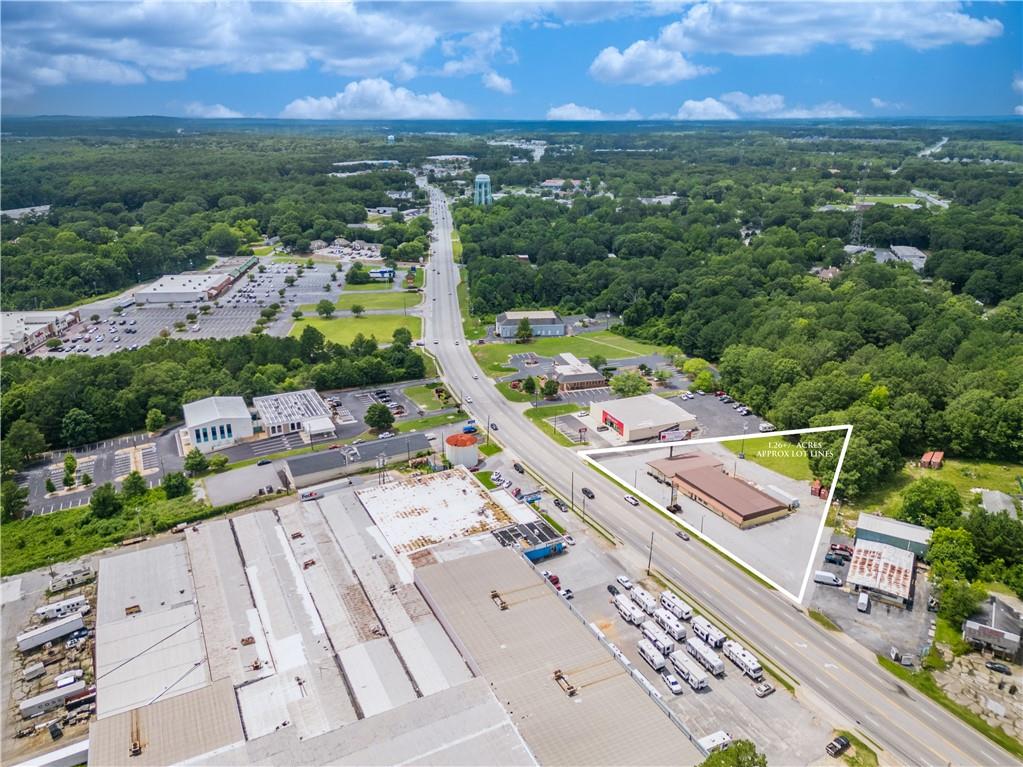PRIME MIXED-USE OPPORTUNITY IN THE HEART OF LOGANVILLE'S MAIN CORRIDOR! This unique and golden property is located in a high-traffic, high-visibility area of Loganville, GA, this exceptional 1.26-acre commercial property offers two freestanding buildings with flexible layout options perfect for retail, office, medical, or restaurant use. Available Spaces: 3,483 SF Building - Ideal for boutique retail, salon/spa, medical office, or professional services 5,250 SF Building - Perfect for a restaurant, showroom, office suites, or multi-tenant configuration Ample paved parking and excellent access Property Highlights: Zoning: Commercial Highway - allows for a wide range of commercial uses. Location: Surrounded by major national and local retailers in Loganville's main shopping district. Visibility: Excellent signage opportunities, including an on-site income-producing billboard. Established Tenant Mix: Current tenants include a gun shop, salon, and hot tub retailer. Strong traffic counts and easy access to major thoroughfares Whether you're expanding your business or launching a new concept, this property offers the exposure and flexibility you need to thrive in a growing market. Contact us today to schedule a private tour and explore your opportunities in beautiful downtown Loganville!