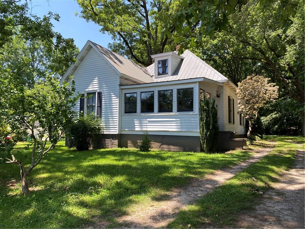 Charming historic cottage located in the heart of Old Town Lilburn. This stunning home features a spacious bedroom and full bathroom on the main level, charming kitchen with plenty of cabinet space, and living room with two decorative fireplaces. Upstairs is the second bedroom or office/workshop. Unique opportunity to live in a gorgeous historic home within steps of everything Old Town Lilburn has to offer! Grab a bite to eat at nearby restaurants, or take a walk on the greenway trail just down the street. Located in the award-winning Parkview school district and close to major highways. Washer/dryer and yard maintenance are included.
