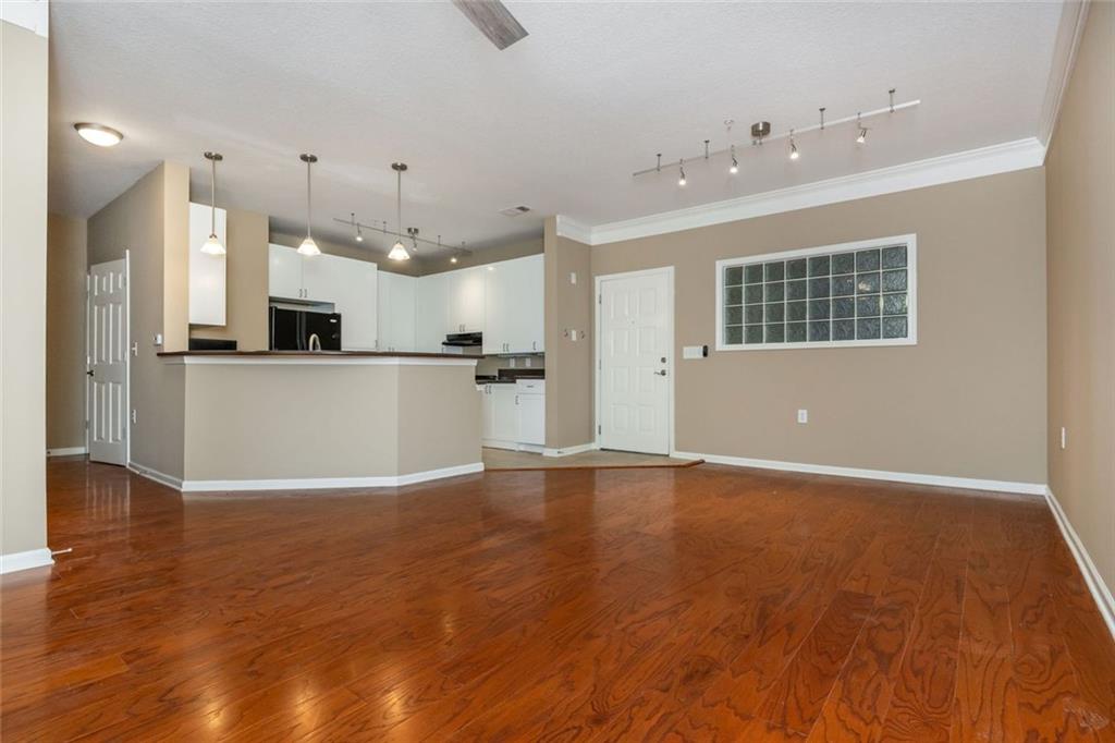 Spacious 1-bedroom with TWO deeded parking spaces—tough to find in Atlantic Station. This unit has wide open living, a wraparound breakfast bar, and space for a proper dining area or home office. It’s also handicap accessible with wider doorways, lower counters, and railings throughout. Hardwood floors, a screened-in porch that overlooks the courtyard, and an oversized bathroom make it feel even larger. It’s an interior corner unit right next to the elevator—easy access in and out. Art Foundry has top-notch amenities: full gym, locker rooms, pool, grilling area, and clubroom. You’ve also got The Commons park right across the street—like having your own Piedmont Park next door. Walk to everything: grocery, Target, IKEA, restaurants, shops, and the Microsoft campus. Minutes to GA Tech, West Midtown, and both interstates. This is city living made easy.