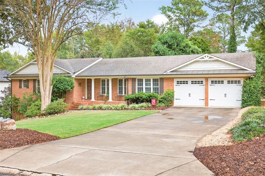 Family Friendly Neighborhood within all things ATHENS and UGA!!! This stunning 4 sided brick, 3BR, 3Bath home is perfect for those who want to enjoy Athens the "Family way" and still be close to so many amenities. Upon entering the front door, you cannot help but notice the gorgeous Hardwood floors and plantation shutters throughout this home. Total open concept with high vaulted ceiling in the main living area that flows directly into the kitchen featuring a massive granite island easily seating 8 people along with a breakfast area. Upgrades galore complete with high end Jennair stainless steel appliances to include a fantastic gas stove, separate microwave, oven/convection oven. The brick wall accent adds that warm and inviting feeling. Off the kitchen is a mud room opening to a screened in porch and attached garage. An amazing feature of this home is the ability to have 3 master bedrooms. On the main level you will encounter a large Master BR with trey ceiling, tiled Master Bath, walk in closet.  The second bedroom could also serve as a master with an attached bath and walk in closet.  Home features a lower level with open stairs making it feel a part of the home and not a basement. The 3rd bedroom again is complete with trey ceiling, an in suite tiled bath and large closet. The lower level has endless possibilities as a second den, exercise room, office, playroom etc. There is also a private entrance from the outside making this a possible in-law suite. You will find this house to have great curb appeal with attractive landscaping and mature trees in both the front and fully fenced backyard. Deck has recently been remodeled making it the perfect setting for entertaining and kids playing. Located in the area of Five Points you are close to so many restaurants, shopping and one of Athens special features Bear Hollow Zoo (walking through a neighborhood trail) great for running, picnics and being one with nature. Very close to the University of Georgia and so much more. This is definitely a must see home!!
