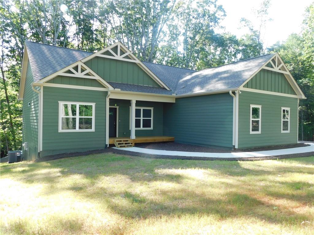 Welcome to your new rental home nestled on a 1.6-acre wooded lot, offering privacy and tranquility. Situated within an exclusive new 9-lot community, this home presents a modern interpretation of spacious living with its single-level open concept design. Step inside to discover a thoughtfully designed split bedroom plan, providing both comfort and functionality. This meticulously crafted home features premium finishes throughout, including custom-built cabinetry, Hardi Siding with board & batten accents, and luxurious LVP flooring. The centerpiece of the living room is a captivating floating electric fireplace with a floor-to-ceiling ship lap surround, adding warmth and character to the space. The gourmet kitchen is sure to impress with sleek granite countertops, stainless steel appliances, and a gas stove, perfect for preparing meals and entertaining guests. Retreat to the owner's suite, a sanctuary of comfort and relaxation, featuring a custom marble shower with a glass door and soaring ceilings that fill the room with natural light. Additional highlights of this home include a 2-car side-entry garage with an opener, a dedicated laundry room with access to the owner’s suite, and an oversized walk-in food pantry. Outside, a rear concrete patio provides space for grilling and outdoor enjoyment, while a covered front porch offers a cozy spot to relax and unwind. Situated conveniently near Historic Dahlonega, the UNG Campus, GA 400, and the new Northeast Georgia Hospital, this home offers both tranquility and accessibility. Don't miss your chance to make this beautifully appointed rental home your own.