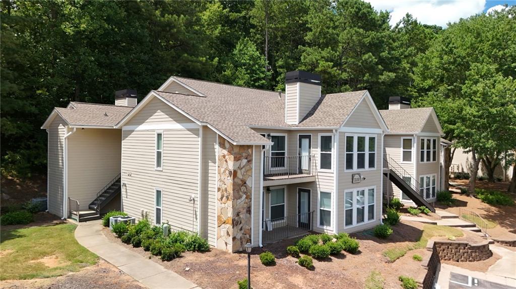 Beautifully maintained Roswell Condo in Prime Location! This lovely ground-level unit features quartz countertops in kitchen & owner’s bath, stainless appliances, soft-close cabinets with pull-out trash & pantry, tile in all wet areas, Shaw LVP flooring (no carpet), designer lighting, LED can lights, and fandeliers in bedrooms. Elegant trim details at fireplace, owner’s suite & guest bath, plus stylish wallpaper in owner’s bath. Freshly painted with Sherwin Williams Duration washable-flat paint and upgraded brushed nickel hardware throughout. Enjoy a private, wooded view from the back patio. Community amenities include a lake with dock, pool, and ample guest parking. One assigned parking spot. Unbeatable location: just 2.5 mi to Downtown Roswell, 0.4 mi to shopping & gas, 2.4 mi to The Avenue East Cobb, and 2.6 mi to the Chattahoochee Nature Center. Move-in ready and truly a must-see!