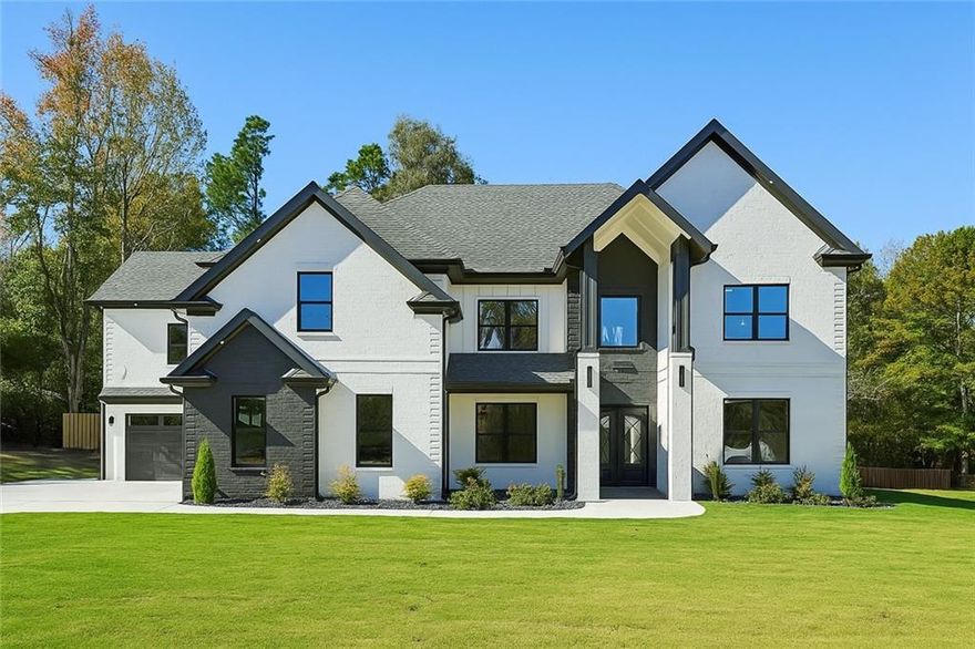 In an Amazing location the home of your dreams awaits... Beyond the gated entrance, this exceptional custom estate exemplifies refined craftsmanship and timeless design. A grand double-door steel entry opens to a dramatic two-story foyer and beautiful entry, soft Venetian plaster accents that flow throughout the home. Oversized primary kitchen and prep kitchen which makes this home an amazing place to entertain.  Engineered white oak hardwood flooring extends across both levels, adding warmth and understated sophistication to every room.
At the heart of the home, the great room features a designer fireplace framed by floating white oak shelves and custom built-ins. Expansive sliding glass doors fill the space with natural light and open to the covered patio, where an outdoor kitchen with built-in grill, sink, and space for a beverage fridge creates the perfect setting for year-round entertaining. A formal dining room nearby offers an elegant space for gatherings and special occasions.
The gourmet kitchen blends beauty and functionality with quartz waterfall counters, custom white oak cabinetry within the island, and farmhouse sink. A separate prep kitchen with JennAir gas range, vented hood, large deep sink, and dual pantries complements a premium JennAir appliance package across both kitchens—perfect for effortless cooking and hosting. Just beyond, a bright breakfast area provides a relaxed space overlooking the backyard.
The main-level primary suite is a tranquil retreat with tray ceiling, accent wall, and a spa-inspired bath showcasing floor-to-ceiling tile, soaking tub, and an oversized shower with rain head and built-in bench. The expansive walk-in closet includes a center dresser island with quartz countertop, chandelier, and bench seating.
Upstairs, a dedicated office with custom built-ins offers a quiet workspace, while the media room—complete with fireplace, wet bar, and beverage fridge—creates a sophisticated space for relaxation or entertaining. Four secondary bedrooms, each with a walk-in closet and private ensuite bath, provide exceptional comfort and privacy for family and guests.
Additional highlights include real marble flooring in the powder room, coffered ceilings, an Ecobee smart thermostat, dual laundry rooms (including a spacious main-level laundry with sink), and a four-car epoxy-finished garage.
Outside, upgraded rock landscaping and a fully fenced yard framed by an upgraded metal fence complete the home’s exceptional exterior design. A beautifully tiled front porch enhances the property’s elegant curb appeal—where every detail reflects intentional design and timeless luxury.