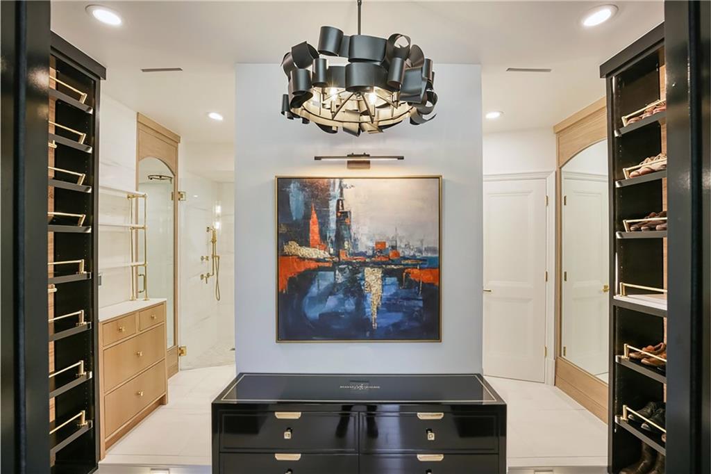 Custom closet system featuring built-in shoe racks and a central island dresser
