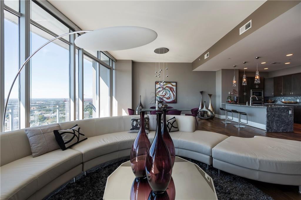 Located above the Loews Atlanta Hotel. Residences showcase 12',  floor-ceiling glass paneled windows. 44"Custom Cabinetry, Thermador appliances, Sub Zero wine refrigerator, Chef Grade Kitchen Venting System, Estate Grade Granite, Hand scraped Brazilian Oak flooring, Victoria+Albert tubs & frameless shower doors. Heated pool, private lounge, access to hotel amenities. 60% Sold Out!