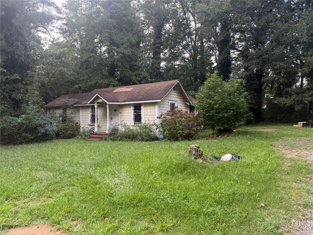 Great investment opportunity! 2-bedroom, 1-bath ranch-style home sits on approximately 0.6 acres and features a cozy family room, kitchen, bedrooms, and a deck overlooking the backyard—perfect for relaxing or entertaining. Built in 1950 and constructed with classic frame materials, The lot provides privacy and plenty of outdoor space to create your own yard oasis. Located in a desirable Stone Mountain Area with easy access to I-285, This home is a smart addition to any investor's portfolio. Sold "As is," with no disclosures. Don't miss out on this solid value in a fantastic location.