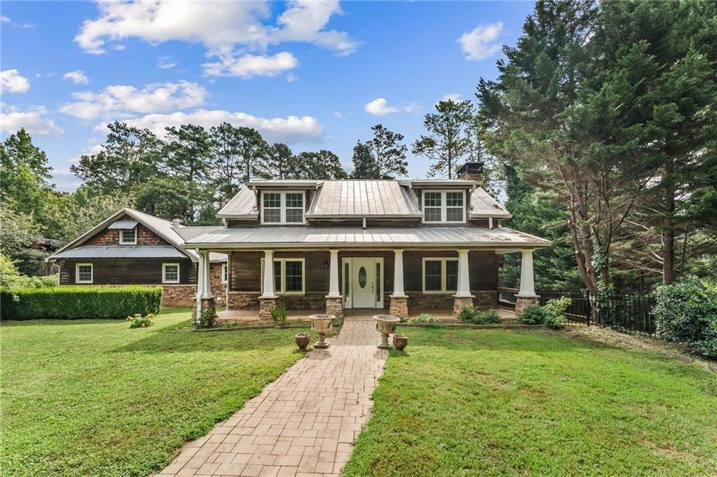 Private, fully fenced 1-acre retreat on 3 parcels – finished basement, outdoor retreat & endless potential in Mableton.
A one-of-a-kind 3-bedroom, 3.5 bath home on three combined parcels totaling over an acre, just off Nickajack Road. Nestled on a private lot with a long, hidden driveway offering plenty of parking, this home offers the perfect blend of space, privacy, and freedom—with NO HOA restrictions.
Bring your RV, boat, trucks, or toys—there’s room for it all! Whether you love to entertain, garden or want space for a home-based business, this home delivers the flexibility to live, host, and expand as you please.
Step inside to find refinished original hardwood floors and custom details throughout. The sunken living room with a fireplace sets a cozy yet elevated tone, while the chef’s kitchen features high end cabinetry, stainless steel appliances, gas stove with convection oven, built-in air fryer, and plenty of space.
The main-level primary suite is a cozy sanctuary with a dual-sink vanity, tiled shower, and a walk-in custom closet. Upstairs, two spacious bedrooms each include walk-in closets, built-in desks, and reading nooks with hidden storage.
This home features a fully finished 1,200 sq ft basement with its own full kitchen, a bathroom, and private covered stone patio & entrance. It’s ideal for entertaining, gym, studio, home office, family room.
The home also offers outdoor living at its best, offering multiple areas to relax, entertain, and enjoy nature in a quiet, tranquil setting. A large rocking chair front porch, the covered lower stone patio or partially covered, large rear patio provide perfect areas for outdoor entertaining or quiet evenings. With many custom details, including a large granite table, fire pit and grill area and a zoned indoor/outdoor speaker system, the opportunities are endless. A large gazebo equipped with ceiling fans and speakers is centered in the expansive garden, ideal for entertaining or special celebrations. A tool/work building next to the large, covered RV parking area offers the perfect place for hobbies, or projects. The yard provides plenty of room to add a pool, or vegetable garden, making this property as functional as it is beautiful.
Additional highlights include a durable metal roof built to last, three HVAC units that provide zoned comfort across every level of the home, and separate entrances for both the main level and the basement, offering flexibility.
Just minutes from several coveted area private schools, Heritage Park, the Silver Comet Trail, and Mable House Amphitheater, this property offers tranquility without sacrificing convenience to the City, Airport and the many sports venues.
This is more than a home—it’s a lifestyle. It is a rare opportunity to own a truly unique Mableton retreat with space to grow, entertain, and live freely. The possibilities are endless.