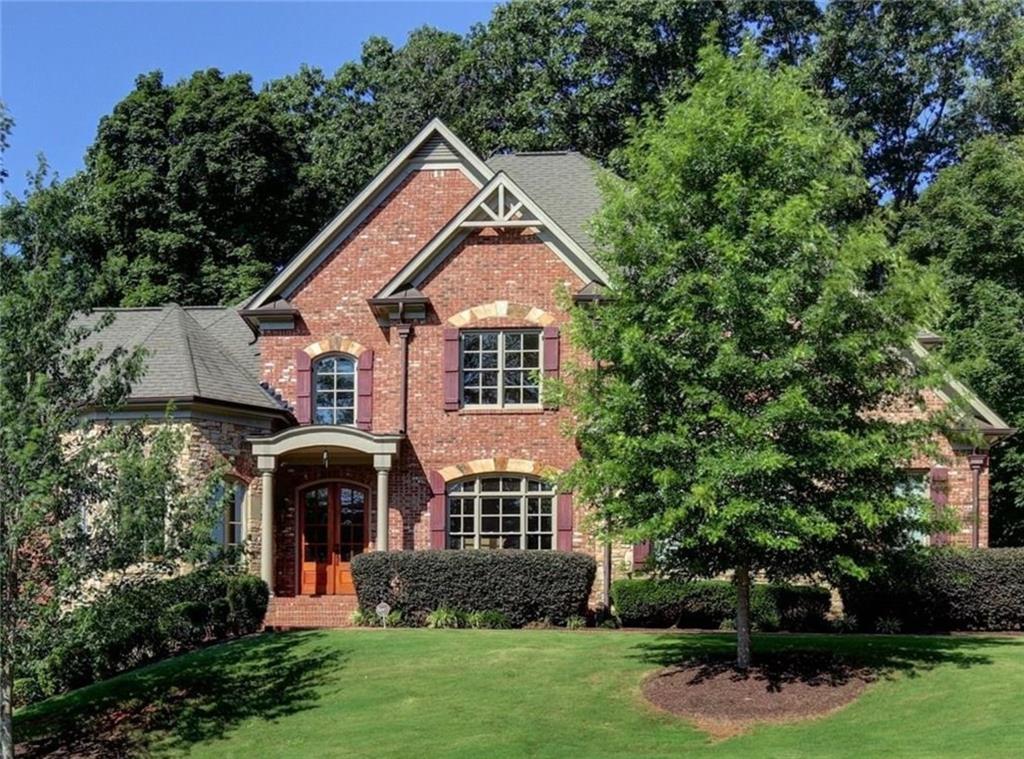 Welcome to this spacious brick home with an owner’s suite conveniently located on the main level. The open floorplan features beautiful hardwoods throughout, complemented by 10-foot ceilings and numerous upgrades. The heart of the home is the huge kitchen, which opens to a keeping room with soaring ceilings and a stunning stacked stone fireplace. Granite countertops and stainless steel appliances add a touch of elegance. Outside is an oasis with a pool. Don't miss out on this magnificent home.