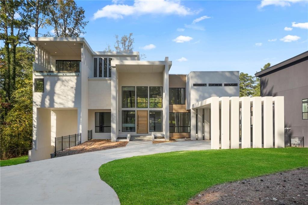 Welcome to this exceptional, custom-designed, new construction, modern contemporary home built by Maison Developement and nestled in the beautiful, North Decatur neighborhood. Meticulously crafted with luxury and detail, this home offers palatial views spread across four levels of unmatched design.
Upon entry, a stunning pivot door leads you to the grand 2-story foyer and great room, with an eye-catching floating staircase accented with frameless glass railings that offer unobstructed views of the home’s modern architecture. Oversized windows throughout the home lend themselves to an abundance of natural lighting. To the right of the entryway is the spacious dining area, anchored by designer lighting that complements the home’s sophistication.The Chef's kitchen features sleek onyx leather quartz countertops with an expansive waterfall island, flat-panel soft-close cabinetry, and a custom oak vent hood. The 6-burner Wolf double oven range is a well appointed gem. An extended walk-in pantry offers ample storage.
The kitchen seamlessly opens to the 2-story great room, which boasts a double-sided fireplace and large sliding doors that lead to a massive balcony, making it ideal for indoor-outdoor entertaining. Adjacent to the great room is a well-appointed bar and den, a versatile space that could serve as an additional private dining area bar or lounge.
Additionally, on the main level, you’ll find a stylish home office and a guest suite featuring a steam shower, private balcony, and walk-in closet. The Junior Primary Suite offers luxury and tranquility with a freestanding soaking tub, grand walk-in shower, double vanity, and direct access to the expansive balcony.
On the upper level, the breathtaking Primary Suite is completed with a double-sided fireplace, sitting area, massive dual walk-in closets and a private balcony. The Primary Bath is a true sanctuary, adorned with floor-to-ceiling tiling, dual rainfall showers, and a striking graphite-colored soaking tub that perfectly complements the black stonework throughout the space. This level also offers spacious Jack-and-Jill bedrooms, along with another ensuite bedroom with distinctive bathroom finishes for added comfort.
The fourth level is both luxurious and versatile, ideal as a private guest suite with a full bathroom, bedroom, and fireside den. Alternatively, this space could function as an office or podcast studio, offering access to front and rear balconies for additional outdoor living accommodations
The fully finished basement features a sweeping 10+ foot bar , a grand family room with a fireplace, and a theater-ready space. A private guest suite ensures comfort and privacy for guests.
This home epitomizes modern luxury and convenience in a sought-after location. Situated minutes from Emory Hospital, the CDC, CHOA, Decatur’s best dining, and entertainment, this estate also offers proximity to Oak Grove Elementary, and a short drive to Buckhead, Midtown and the Airport.