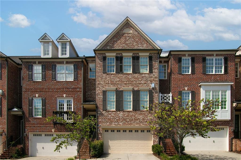 Prime Downtown Alpharetta Location!!! Welcome to 535 Rose Garden Lane in Awesome Alpharetta! Steps away from amazing dining, shopping, the Alpha-Loop Walkway, The Green Downtown Entertaining Area, parks and all of the amazing events this Top Rated city has to offer. This beautiful 4 bedroom, 3 1/2 bath home is located in one of the premier neighborhoods of the downtown district. You'll enjoy plenty of parking with a double garage, double driveway and guest parking. On the main level you'll find a spacious and open entertaining-style living area, dining area and kitchen with a walk-in pantry, soaring ceilings, a fireplace, built-ins and access to your balcony. The spacious primary bedroom is located on the third level with a large walk-in closet and in the primary bathroom you'll find a soaking tub, walk-in shower and a double vanity. Also on this level are 2 comfortably sized guest rooms (one with a walk-in closet), a full bath with a double vanity and a conveniently located laundry room. On the lower level is a large bedroom/den with a full bath and direct access to the cozy and private backyard with fenced room for your fury friends. The wooded lot offers privacy in the rear of the home with no other yard directly behind. New interior paint throughout and 3rd floor hardwood. This beautiful home is located in a very quiet and peaceful section of The Georgian Townhome Community in Alpharetta, consistently ranked as one of the top places in the country to live, work and play. Come see why we call it Awesome Alpharetta!