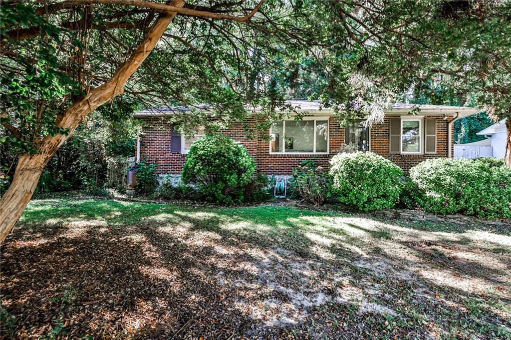 Charming brick home in the heart of Medlock Park, just moments from the neighborhood playground, park, and South Peachtree Creek Trail. Zoned for top-rated Fernbank Elementary and located only minutes from downtown Decatur, this home also offers easy access to the exciting new Lulah Hills development. Inside, you’ll find a beautifully updated kitchen with butcher block countertops and modern tile, a spacious and light-filled sunroom, and multiple areas perfect for entertaining. The primary suite features generous his-and-her closets, offering plenty of storage and comfort. Outside, the private backyard is a true retreat with flagstone patios, multi-level terraces, and lush landscaping designed for relaxing or hosting gatherings. With its warm character, modern updates, and unbeatable location, this Medlock Park gem perfectly blends comfort, convenience, and charm.