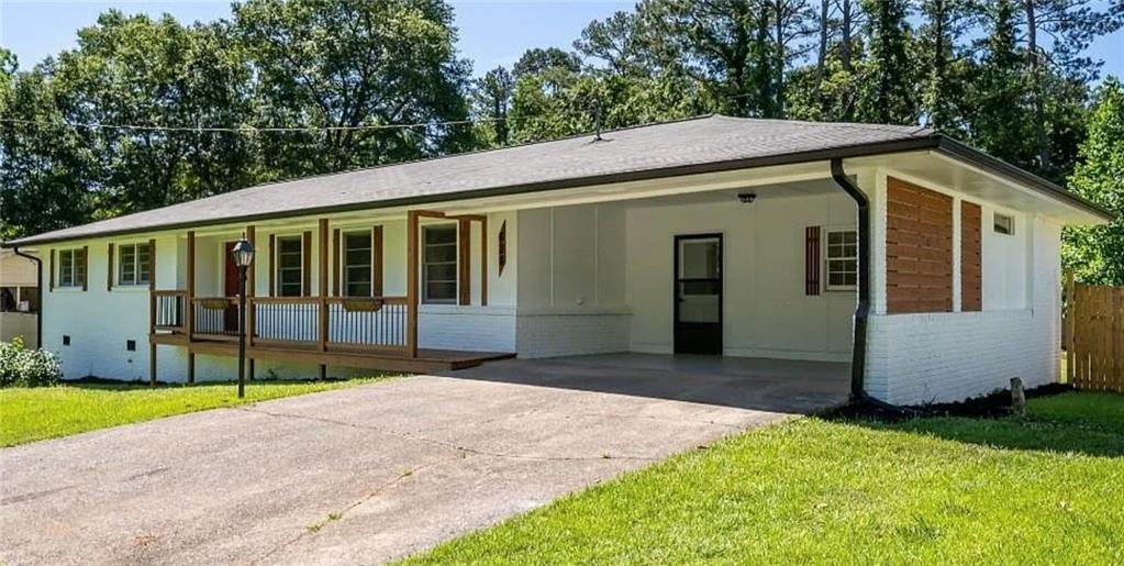 Welcome to this beautiful and fully renovated 3 bedroom, 2 bathroom ranch style home. Nestled into a quiet, desirable area of Marietta - WITH NO HOA restrictions. This house is brick on all four sides. The spacious kitchen is straight out of a designer's dream, with a large island, quartz countertops, all new appliances, pot filler, custom hood, and walk in pantry. The kitchen opens up to the living room, complete with a fireplace and large dining area. Right off the living room is a screened in back porch that overlooks the very large fenced in, private backyard. There is a a large workshop/shed in the backyard, complete with power outlets that remain with the property. A portion of the carport was enclosed to create additional storage and a large laundry room. This area also serves as the perfect mudroom or place to drop everything when coming home from work or school. There is so much to love about this house, you don't want to miss seeing it!