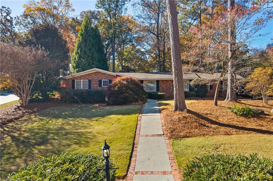 You have found the perfect Sandy Springs ranch! This beautifully updated 3-bedroom, 2.5-bathroom brick ranch is nestled on a corner lot and offers over 2500 sq ft of one level living in coveted Westfield Park. Enjoy the large kitchen with plentiful counter space and carefully crafted custom cabinets with thoughtful design extending into the attached, open family room.  A fireplace in the family room keeps you warm while you visit with guests or family. Let the party spill into the adjoining vaulted sunroom with 180 degree views of the colorful back yard.    Adjacent to the kitchen a light filled spacious dining room offers a more formal entertaining experience.  It opens to the large front living room perfectly suited for a grand piano with space to spare.   All of the living areas feature original, pristine hardwood floors.  The numerous thoughtfully designed closets throughout the home are well appointed and offer plenty of storage.  In the primary bedroom you will find an ensuite bathroom with a large shower and two closets.  Each of the two guest rooms are serviced by a good sized hall bath with an original tub/shower combination.  This home offers too many features to list but in short, there is a large fenced back yard with patio, double garage with extra parking pad, whole house generator, instant hot water in kitchen, excellent dry storage in the basement and much much more.  Enjoy all the restaurants, shopping and convenience of Sandy Springs so close to this incredible home.