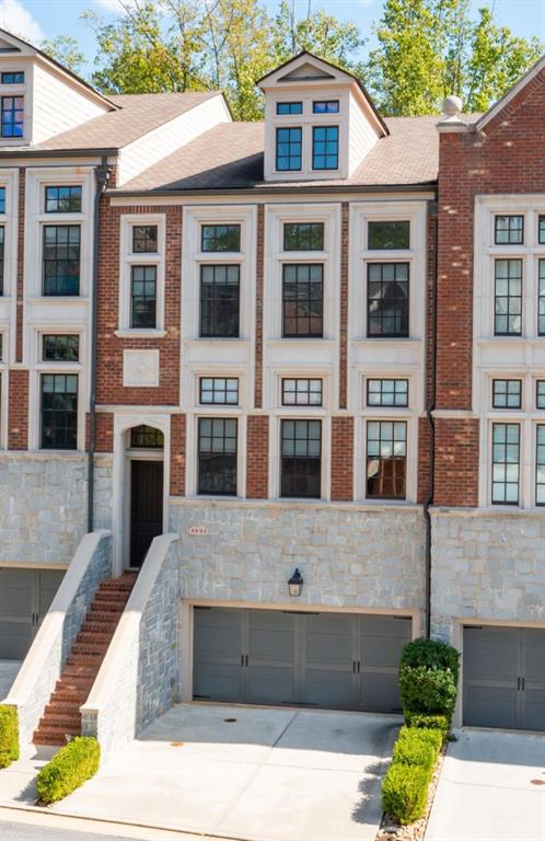 Modern luxury meets timeless Brookhaven charm in this striking 4-story townhome within the gated Savoy at Town Brookhaven community! Designed by Ashton Woods, this residence blends sophisticated design with a true walk-everywhere lifestyle - just steps from the vibrant Town Brookhaven district. The terrace level offers a full suite currently used as a glam room with sitting area, full bath, and walkout patio. The second floor features a guest bedroom with twin closets, full bath, additional living space, and a private covered deck. The main level showcases a show-stopping kitchen with JENN-AIR appliances, a massive island, microwave drawer, built-in refrigerator with custom cabinetry, walk-in pantry, and detailed millwork - opening to a fireside family room with built-ins, abundant natural light, an additional sitting area, and another covered deck perfect for entertaining. The top floor hosts an additional bedroom suite, office nook, laundry room, and an oversized primary retreat with a luxury spa-inspired bath featuring a soaking tub, tiled shower with dual shower heads, water closet, and custom walk-in closet. Soaring ceilings, elegant designer fixtures, hardwood floors, and a built-in speaker/intercom system elevate every level. HOA includes exterior dwelling maintenance, landscaping, and resort-style pool with outdoor fireplace and grilling area just across the street. Ideally located adjacent to Town Brookhaven, a lively destination for dining, shopping, and entertainment, and just minutes to additional local hubs and parks offering endless outdoor recreation, community events, and green spaces. Convenient to the Brookhaven/Oglethorpe MARTA station with quick access to Buckhead, Midtown, and Perimeter, all within the top-rated Chamblee Charter school cluster. Experience the best of Brookhaven - where modern convenience, walkable living, and gated serenity meets an energetic, connected community!