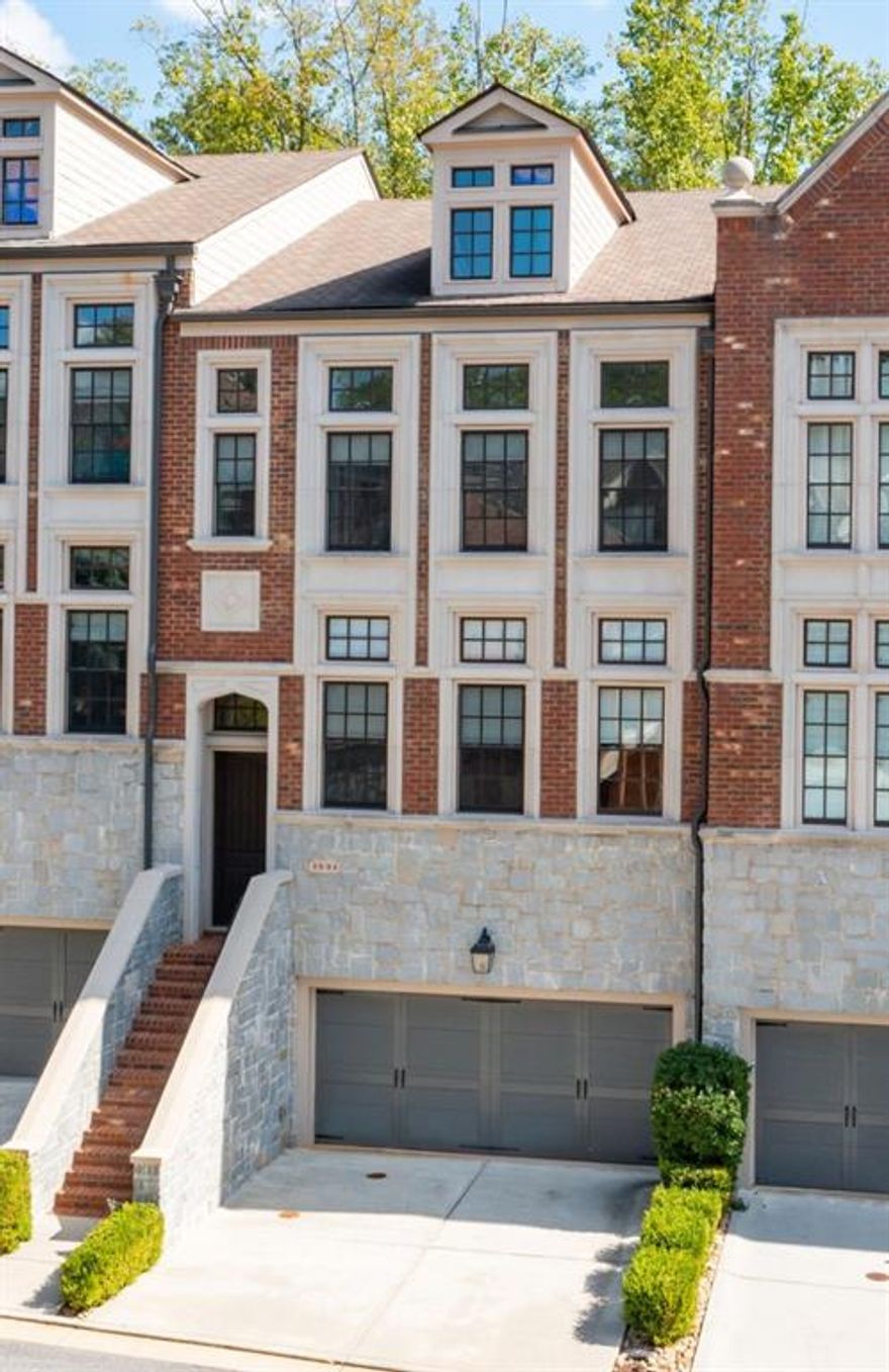 Modern luxury meets timeless Brookhaven charm in this striking 4-story townhome within the gated Savoy at Town Brookhaven community! Designed by Ashton Woods, this residence blends sophisticated design with a true walk-everywhere lifestyle - just steps from the vibrant Town Brookhaven district. The terrace level offers a full suite currently used as a glam room with sitting area, full bath, and walkout patio. The second floor features a guest bedroom with twin closets, full bath, additional living space, and a private covered deck. The main level showcases a show-stopping kitchen with JENN-AIR appliances, a massive island, microwave drawer, built-in refrigerator with custom cabinetry, walk-in pantry, and detailed millwork - opening to a fireside family room with built-ins, abundant natural light, an additional sitting area, and another covered deck perfect for entertaining. The top floor hosts an additional bedroom suite, office nook, laundry room, and an oversized primary retreat with a luxury spa-inspired bath featuring a soaking tub, tiled shower with dual shower heads, water closet, and custom walk-in closet. Soaring ceilings, elegant designer fixtures, hardwood floors, and a built-in speaker/intercom system elevate every level. HOA includes exterior dwelling maintenance, landscaping, and resort-style pool with outdoor fireplace and grilling area just across the street. Ideally located adjacent to Town Brookhaven, a lively destination for dining, shopping, and entertainment, and just minutes to additional local hubs and parks offering endless outdoor recreation, community events, and green spaces. Convenient to the Brookhaven/Oglethorpe MARTA station with quick access to Buckhead, Midtown, and Perimeter, all within the top-rated Chamblee Charter school cluster. Experience the best of Brookhaven - where modern convenience, walkable living, and gated serenity meets an energetic, connected community!
