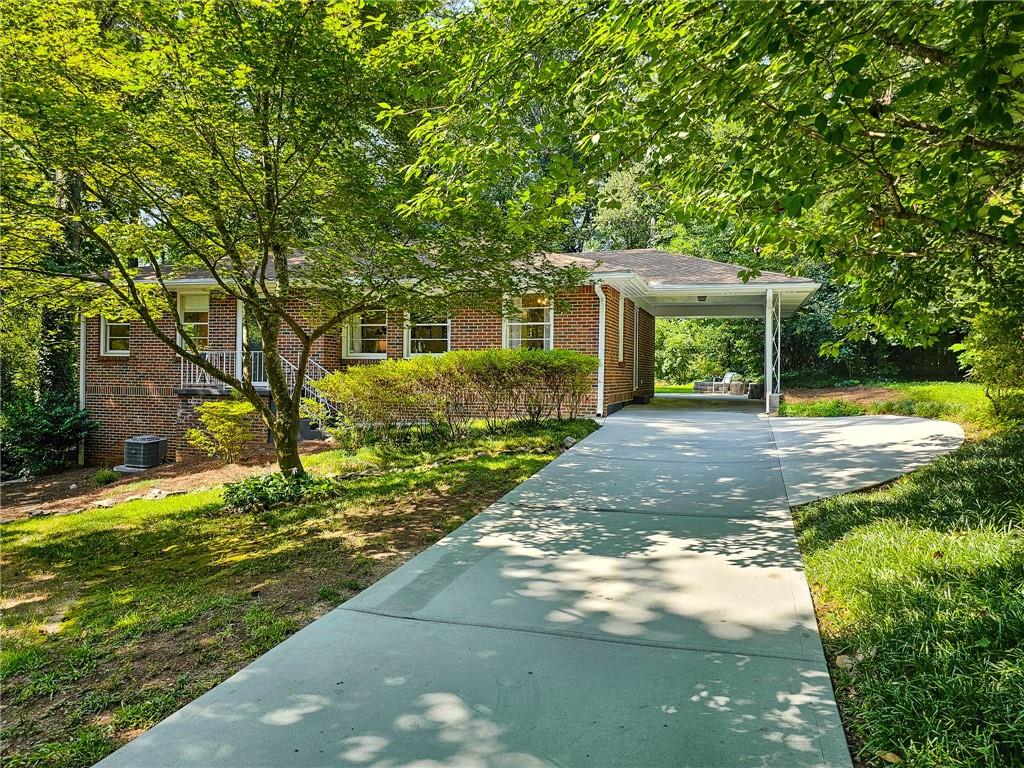 Check out the 3d virtual tour! This 3 bed 1.5 bath ranch is picture perfect from the street to the interior to the back yard! Medlock Park is one of the most desirable neighborhoods and this home sits on a quiet street. As you enter, you are greeted by gleaming hardwood floors. The large light-filled living room leads right into the dining and kitchen areas, where you’ll find an updated kitchen with white cabinetry, stainless steel appliances, and access to the carport. From the kitchen you have easy access to the large patio and lush backyard, this allows you to fully enjoy privacy and create an ideal outdoor experience. The primary bedroom features an ensuite half bath, room for a king bed, and sitting area. In addition, the main floor features 2 additional bedrooms and a hall full bath. The lower level includes a large extra living space, a dedicated laundry room, and plenty of room for storage. The home features a 1 car carport and the driveway has a parking pad for side-by-side parking. All appliances remain with the home. Convenient to Emory/CDC/CHOA, as well as the new Church St. retail and restaurant district, Downtown Decatur, Shamrock Shopping Plaza, Toco Hill shopping & restaurants, and major roads.