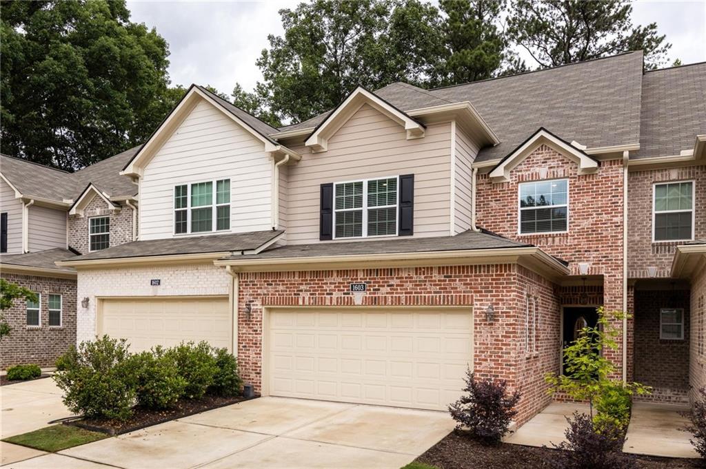 Tucked inside a quiet, gated community in Marietta, this newer construction home delivers the perfect mix of comfort, convenience, and calm. Just minutes from the charm of Marietta Square, the location makes everyday life easy without sacrificing peace and privacy. Step inside to warm hardwood floors and an open main level that feels spacious and welcoming. The living room centers around a cozy fireplace and flows effortlessly into the kitchen and dining area, creating a space that’s just as great for relaxing as it is for hosting. The kitchen is the heart of the home, featuring a large central island, stainless steel appliances, granite countertops, gas range, and abundant cabinetry to keep everything within reach yet out of sight. French doors off the dining area lead to a private patio surrounded by lush greenery, giving you that tucked-away, treehouse feel. Whether it's coffee in the morning or wine in the evening, this space is made for slowing down. Upstairs, you’ll find two generously sized guest bedrooms, a full bathroom, and a laundry room that keeps chores contained. The oversized primary suite is a true retreat with space to unwind, a large walk-in closet, and a spa-inspired bathroom with double vanity, walk-in shower, and separate water closet. There’s more to love; the huge unfinished basement is already stubbed for a bathroom and ready for whatever you need next, think home gym, guest suite, office, or media room. Enjoy socializing with neighbors at the community pool and let the pups run free at the dog park. Conveniently located near I-75, this one checks all of the boxes and then some!