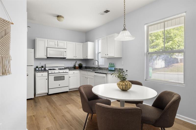 Ideally located just minutes from Highway 78 and I-285, this move-in-ready townhome offers easy access to major commuter routes, everyday essentials, and local favorites. Grocery stores like Kroger and Walmart are just around the corner, while Stone Mountain Park and Yellow River Park are nearby for outdoor recreation and weekend adventures. This well-maintained 3-bedroom, 2.5-bathroom home features fresh paint throughout, brand new LVP flooring on the main level, and updated granite countertops in the kitchen. The main floor includes a spacious dining area, a functional kitchen with breakfast nook, and a bright, open living space with abundant natural light. An exterior storage unit offers added convenience. Upstairs, you'll find a large primary suite with its own en-suite bathroom, plus two additional bedrooms perfect for guest rooms, a home office, or extra living space. Don't miss this opportunity to own a centrally located, turnkey home with great financing options!
