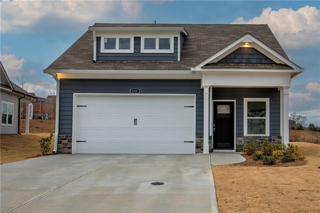 Special End Of Year Incentive. $10,000. to be used towards closing costs or a price reduction with any acceptable offer written before the end of this year. On this home only.
The LeMay. This newly constructed home boasts a two-car garage, a cozy sitting room, and a coat closet in the entryway. As you walk in, you'll be greeted by a spacious great room and dining area, all open to the kitchen perfect for gatherings and entertaining. The primary suite is designed for comfort, featuring a large window that fills the room with natural light and a generous closet to accommodate all your clothing needs. Primary suite bathroom has double sink vanity and a curbless entry tile shower. Main level also hosts the secondary bedroom and a laundry room. Upstairs is a Finished Bonus Room, and Full Bathroom.This could be used as a third bedroom or for whatever your imagination desires. Lots of upgrades are already included, kitchen tile backsplash, 2 ceiling fans on back porch, Finished Bonus Room, and all the extras you can add to the primary shower are already there. All this in a quaint 55+ active adult community with fully sodded yards, front, back and side maintained by the HOA. Photos are of similar plan, some features may vary.